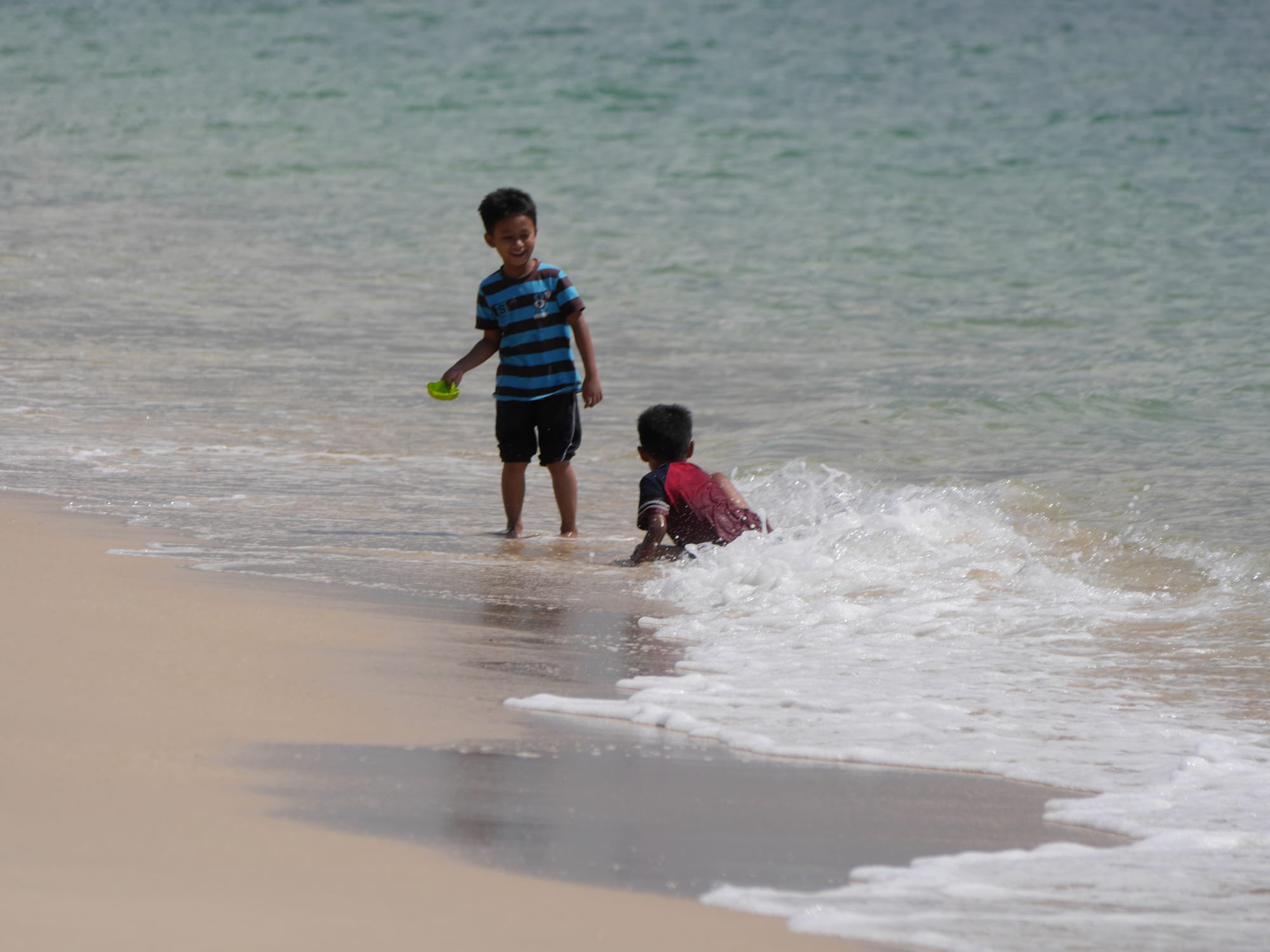 Photo by Author — kids in the surf — Desaru Beach, Kota Tinggi, Johor, Malaysia