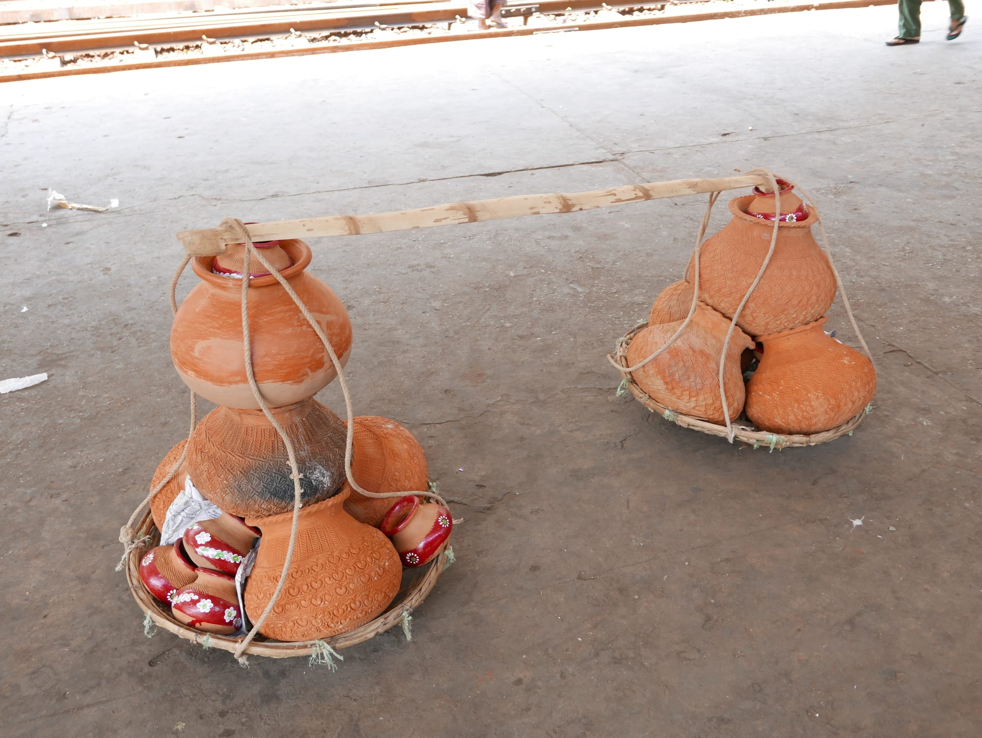 Photo by Author — pots stacked on the platform — Yangon Train Station