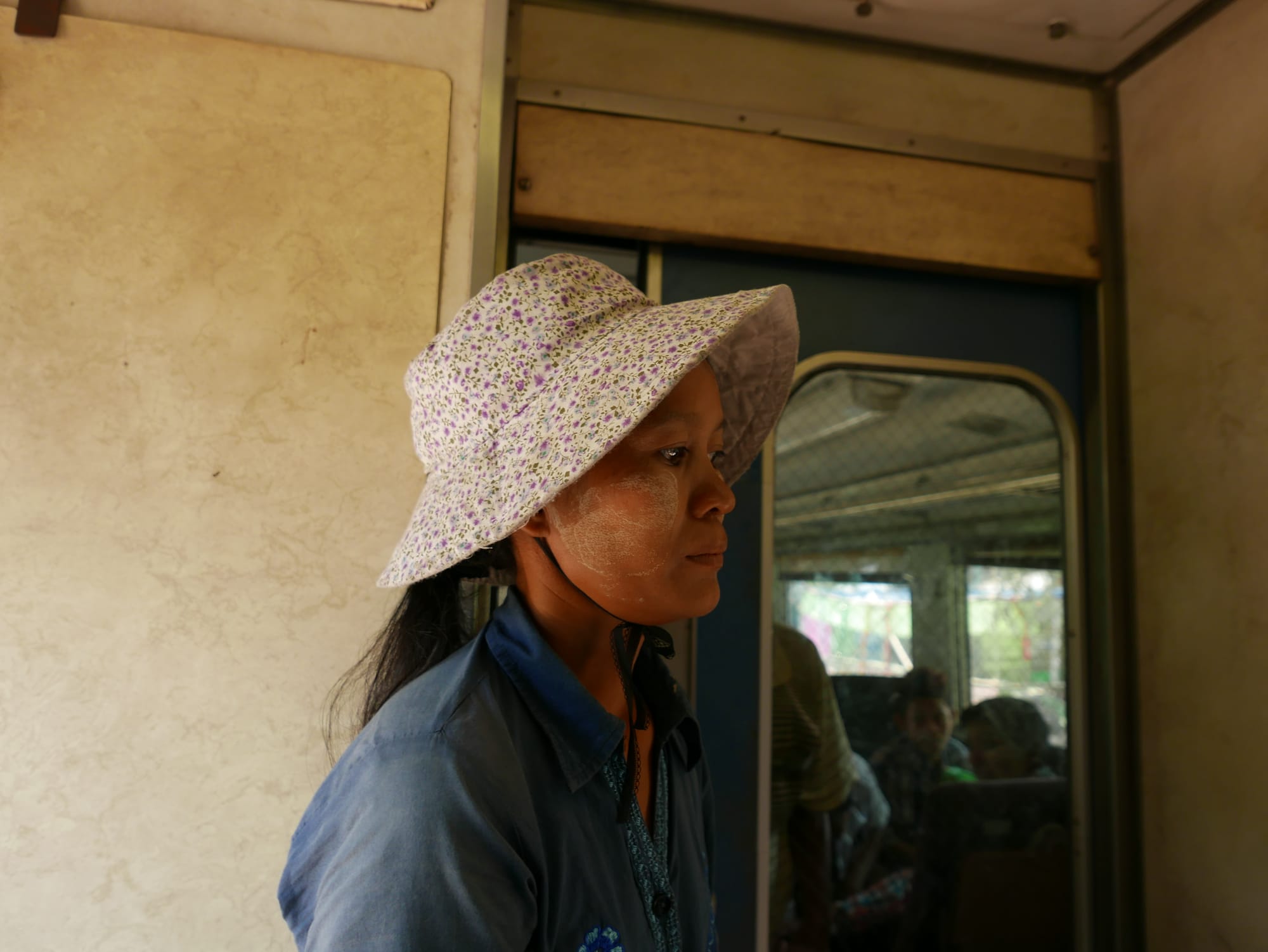 Photo by Author — train passenger with yellow paste, thanaka — Myanmar (Burma)