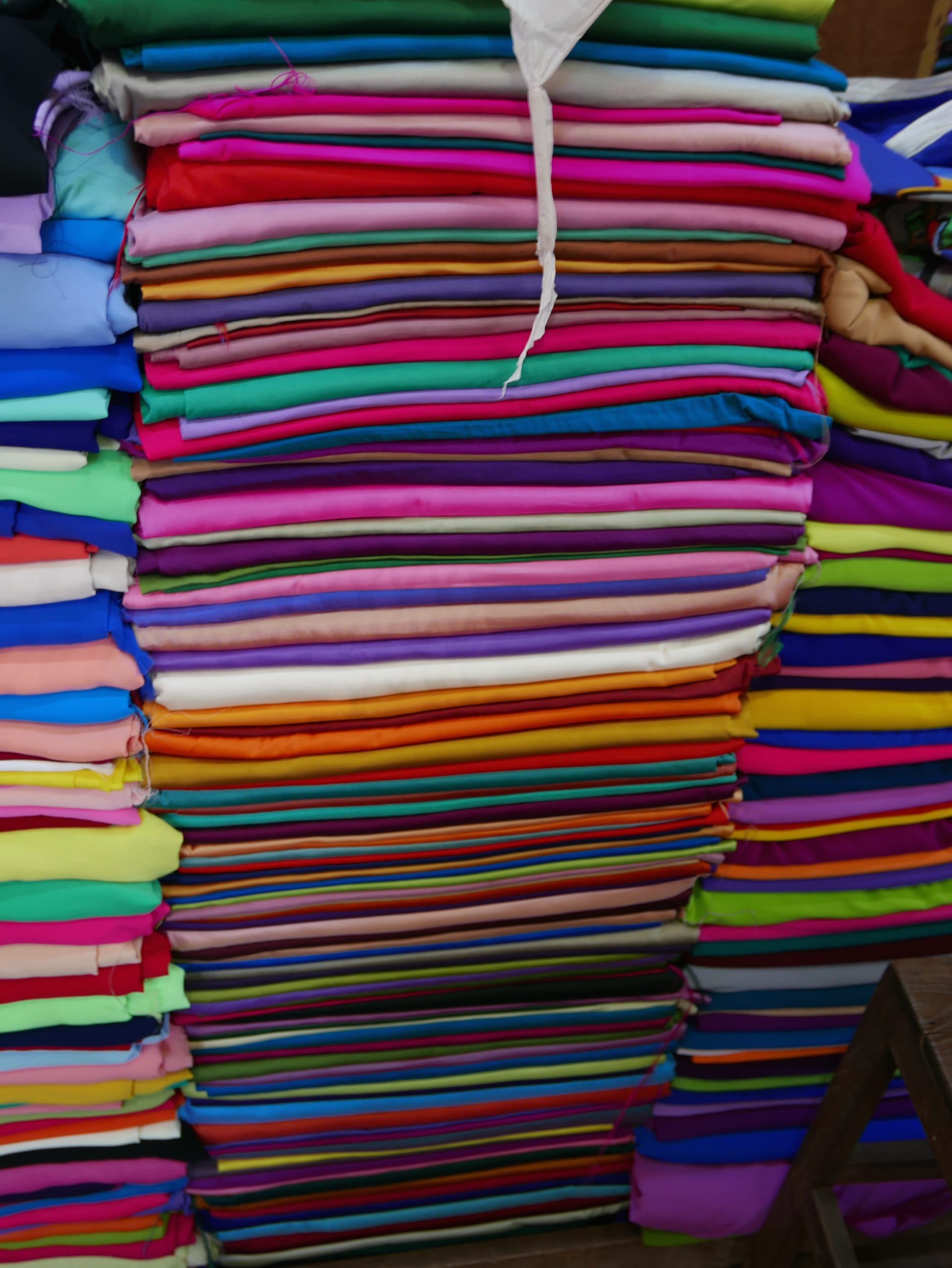 Photo by Author — stacked cloth for sale — Bogyoke Market (Scotts Market), Yangon (Rangoon), Myanmar (Burma)