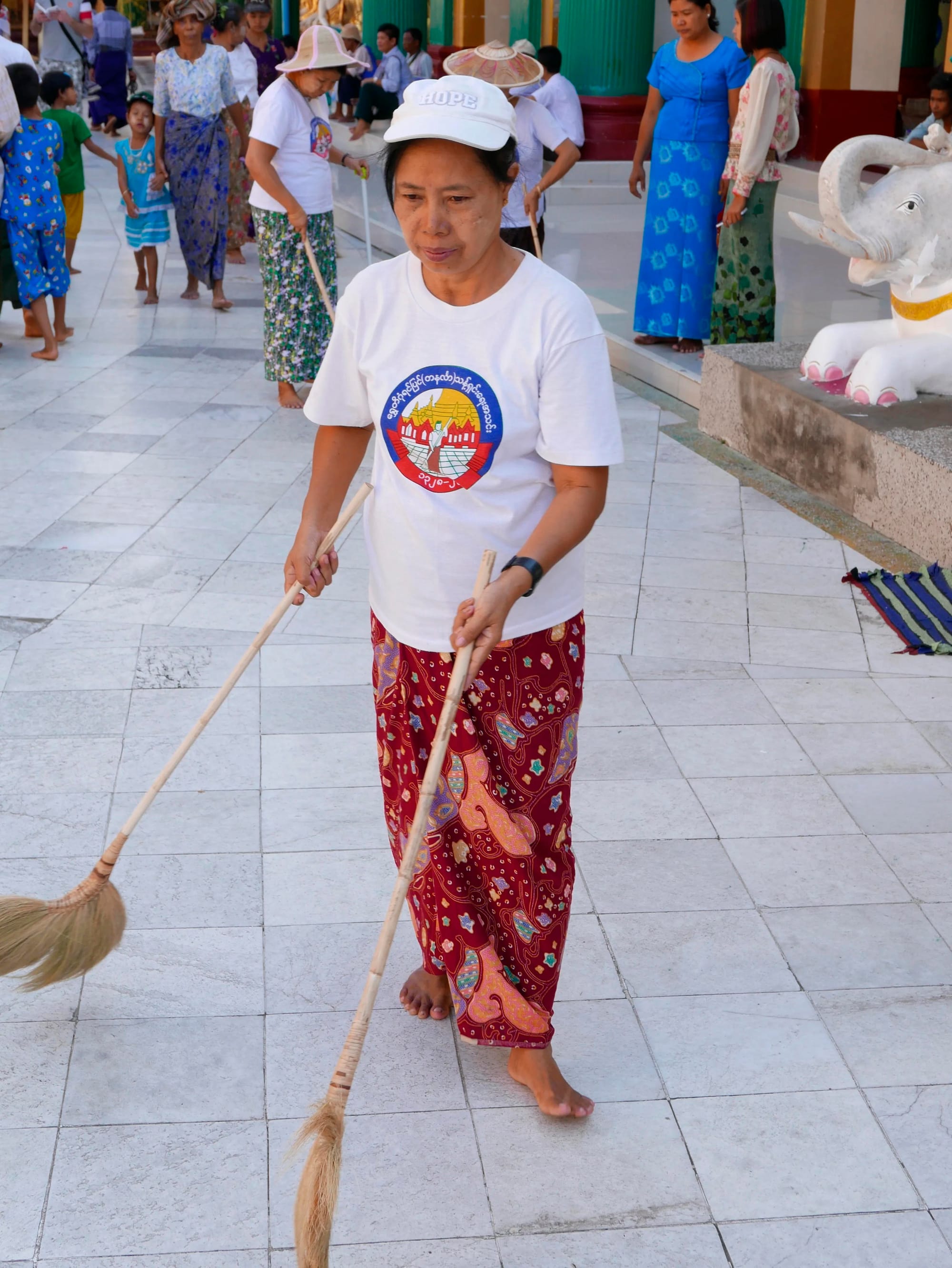Photo by Author — a cleaner at the Shwedagon Pagoda