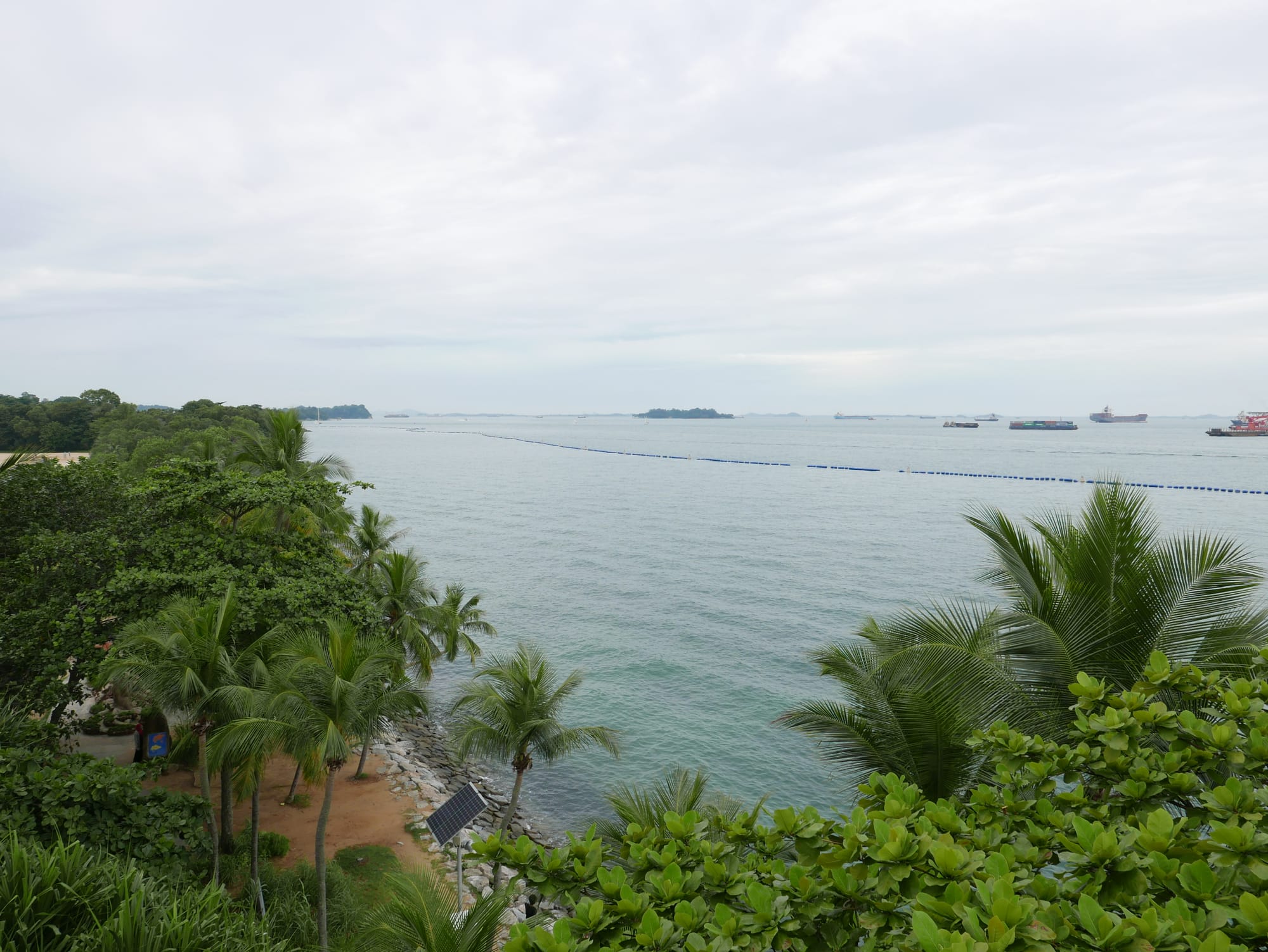 Photo by Author — looking out to sea (note all the ships) — Palawan Island, Sentosa Island, Singapore