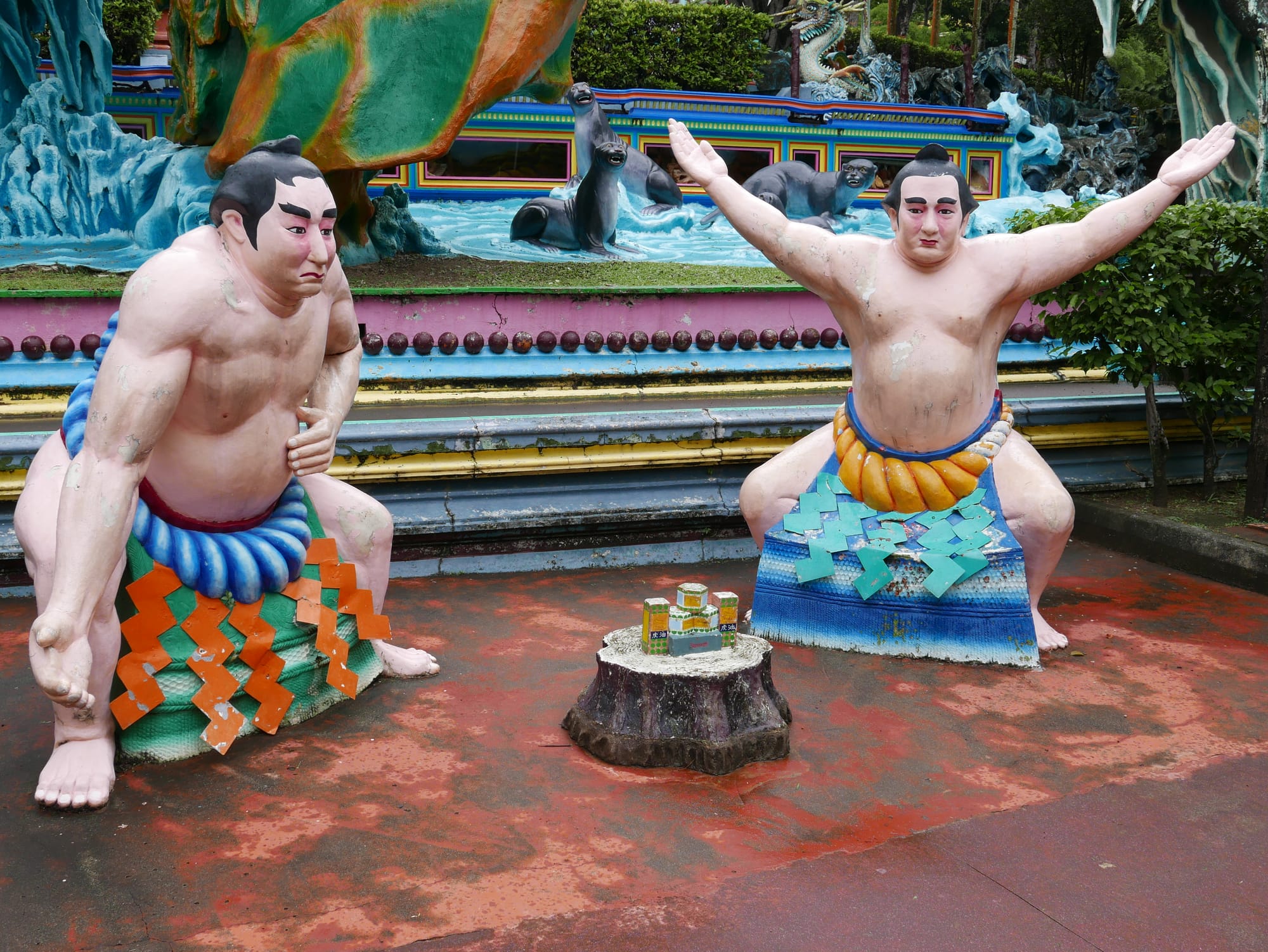 Photo by Author — two sumo wrestlers praising Tiger Balm — Haw Par Villa, Singapore