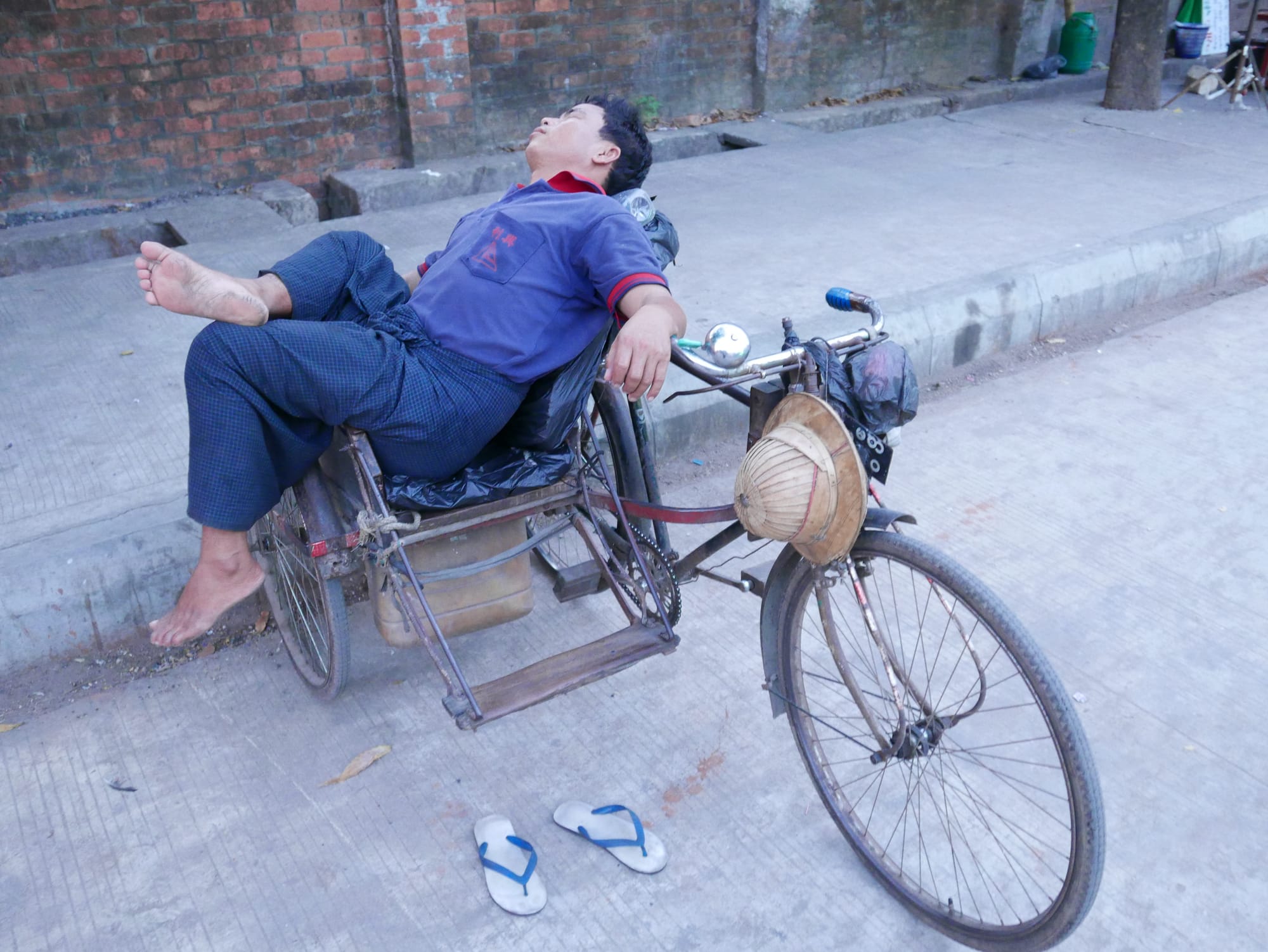 Photo by Author — bike taxi driver napping — Myanmar (Burma)