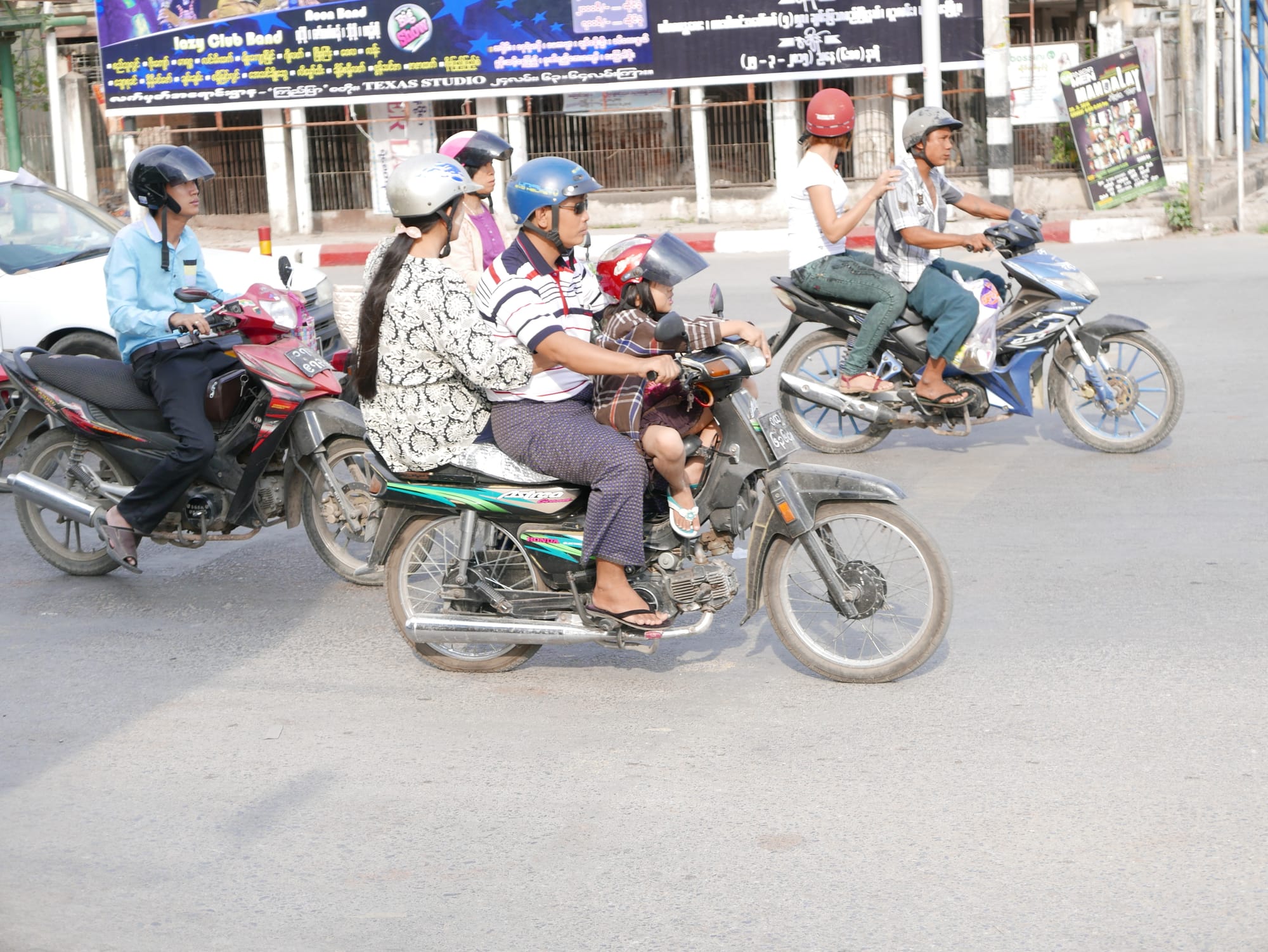 Photo by Author — three up at the lights — motorbikes of Mandalay