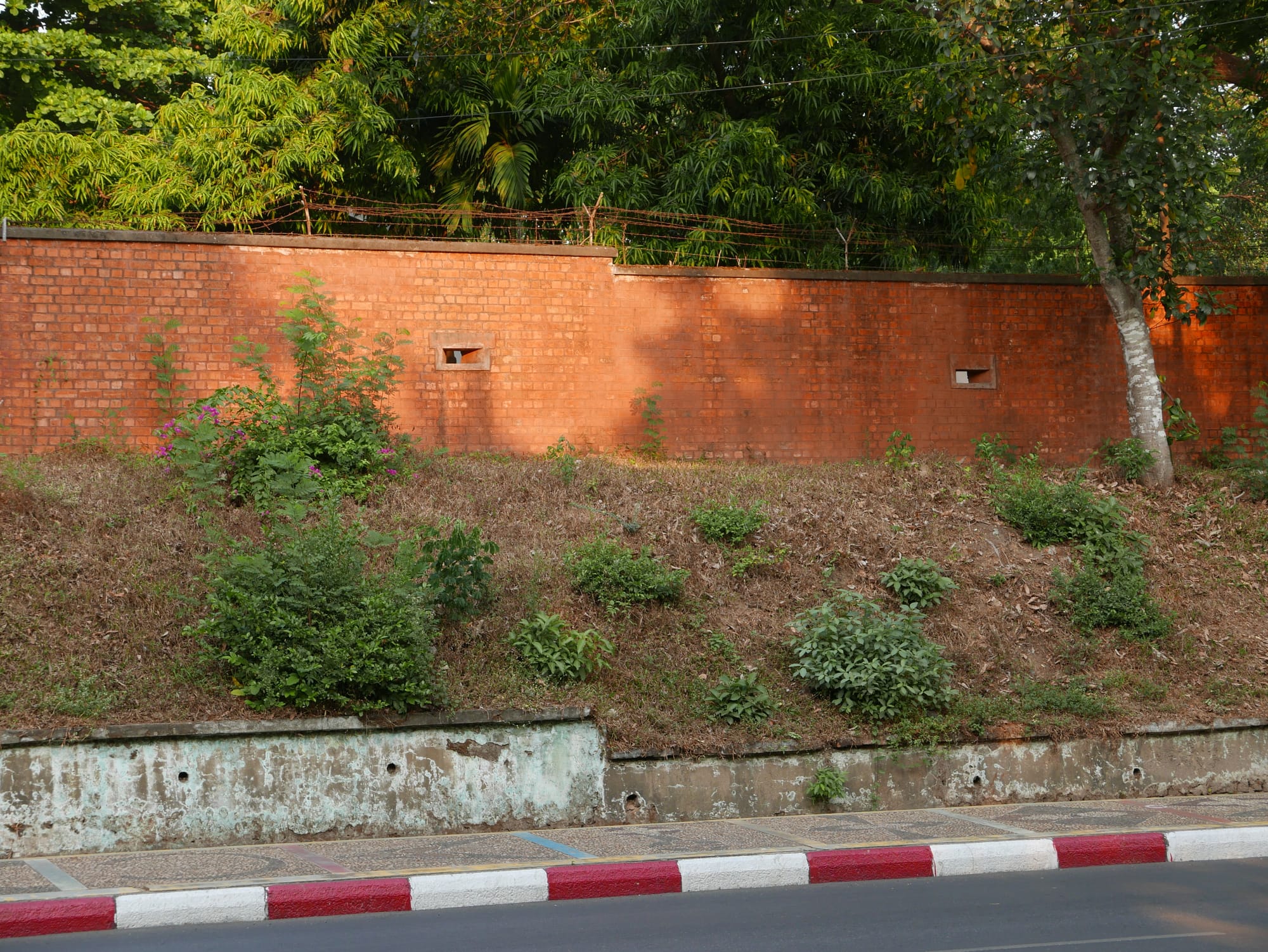 Photo by Author — a wall with rifle slots — Yangon