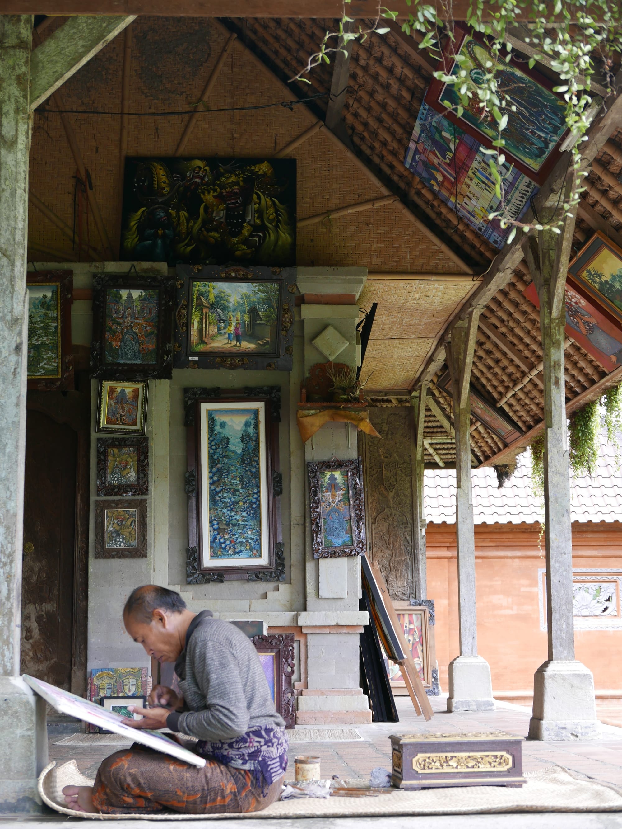 Photo by Author — an artist at work at the Pura Taman Ayun, Bali, Indonesia — a Royal Water Temple