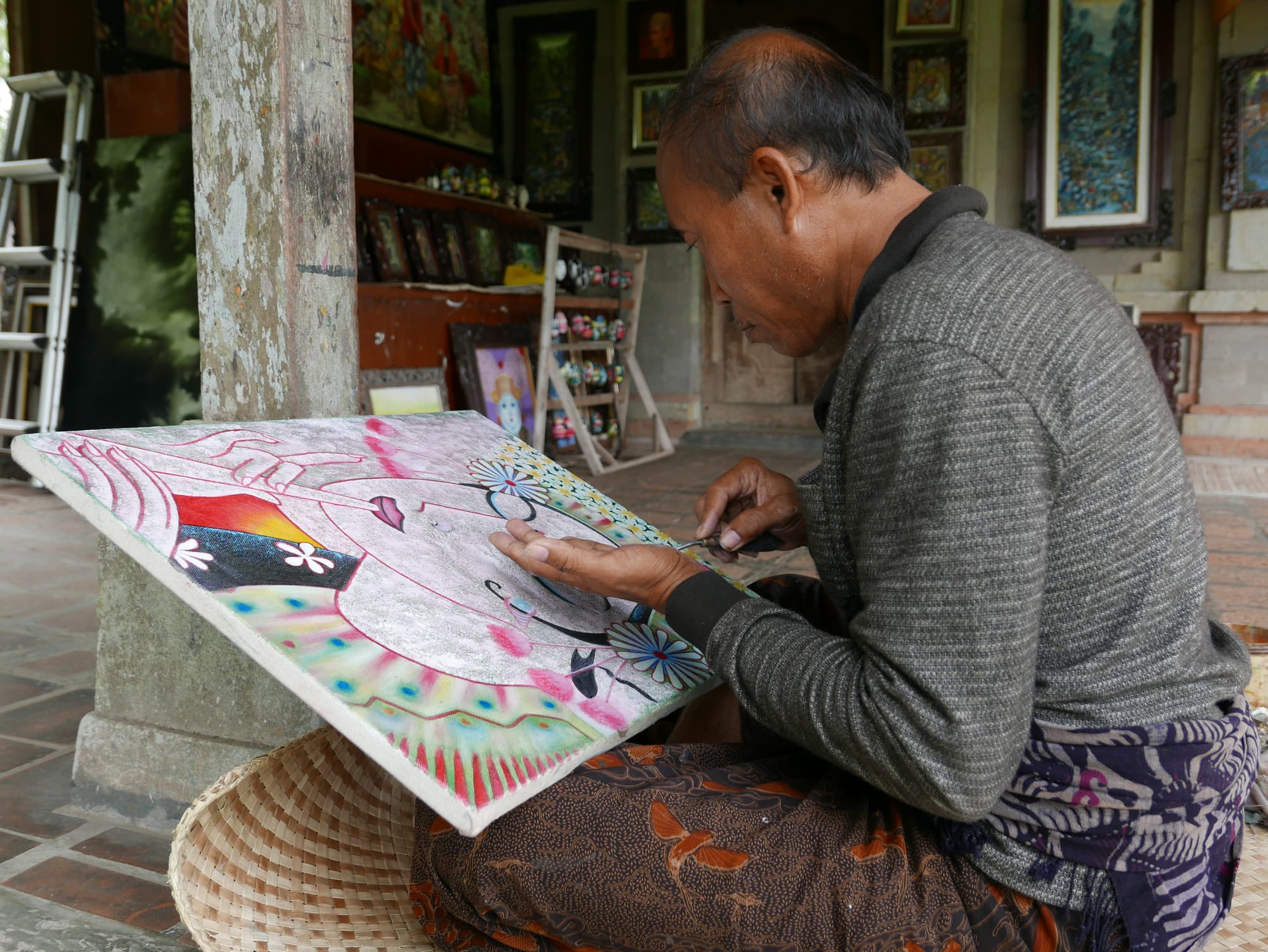 Photo by Author — an artist at work at the Pura Taman Ayun, Bali, Indonesia — a Royal Water Temple