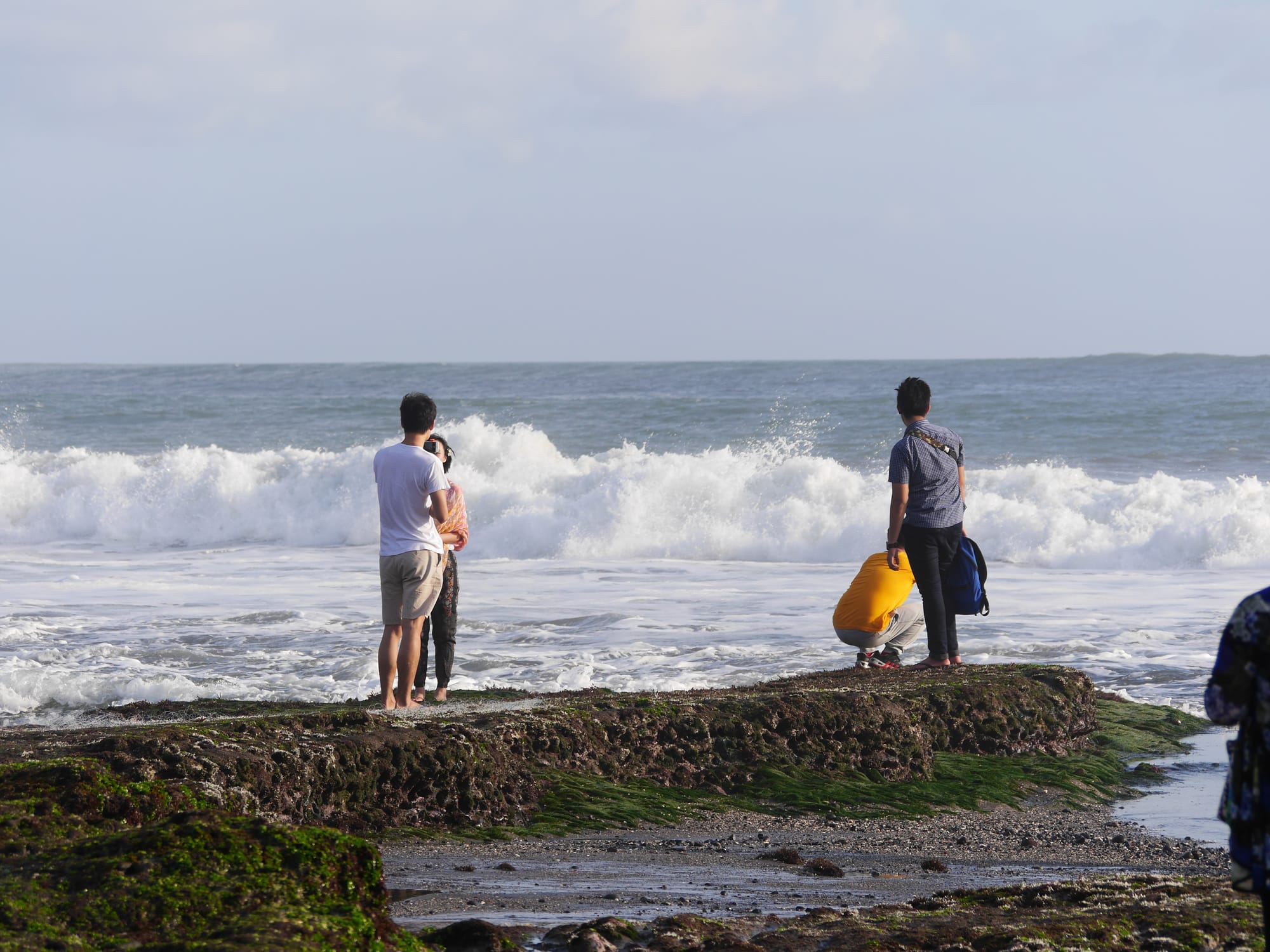 Photo by Author — tourists on the beach at Tanah Lot, Bali, Indonesia