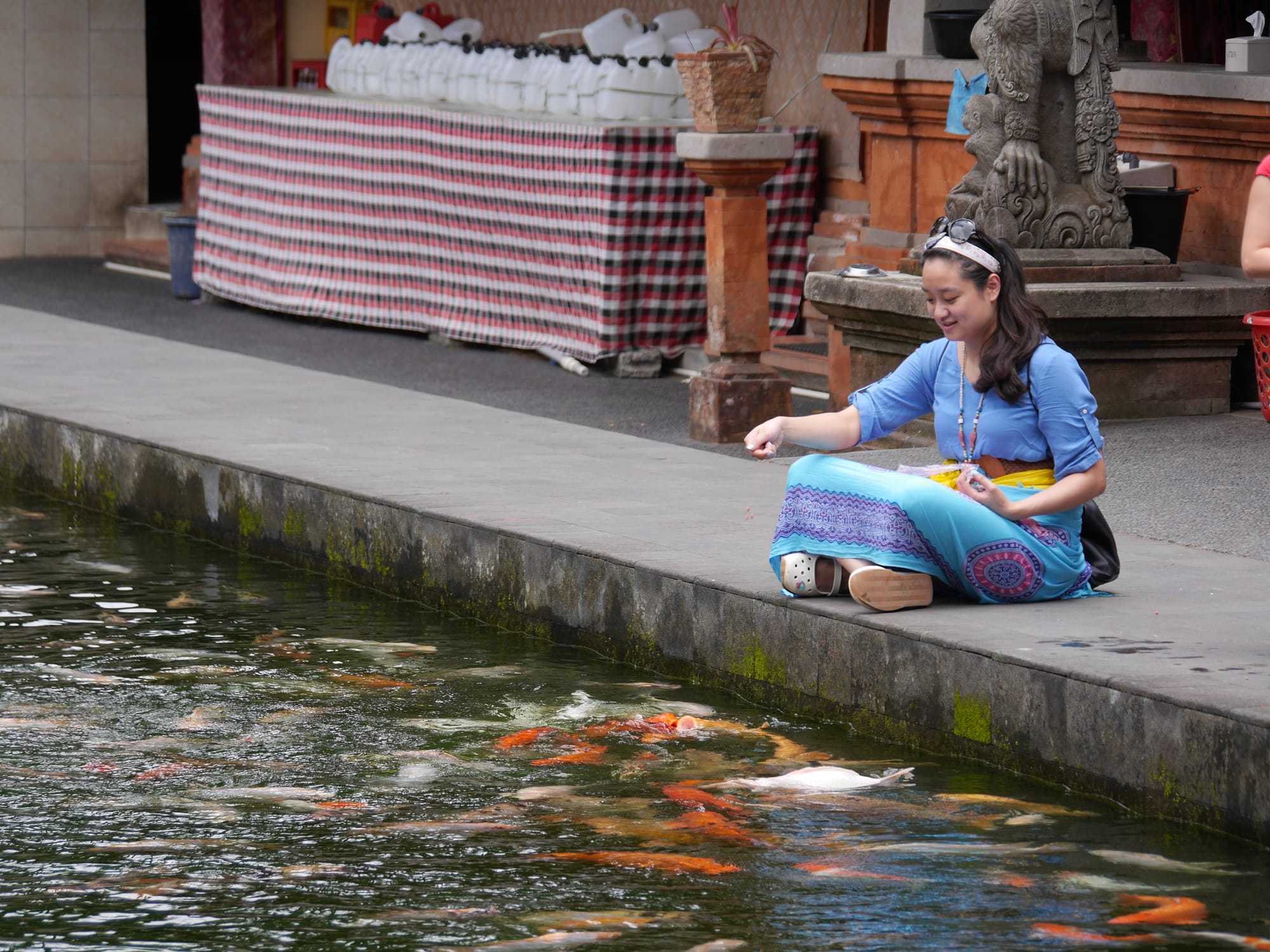 Photo by Author — feeding the fish — Pura Tirta Empul (Tirta Empul Temple), Bali, Indonesia