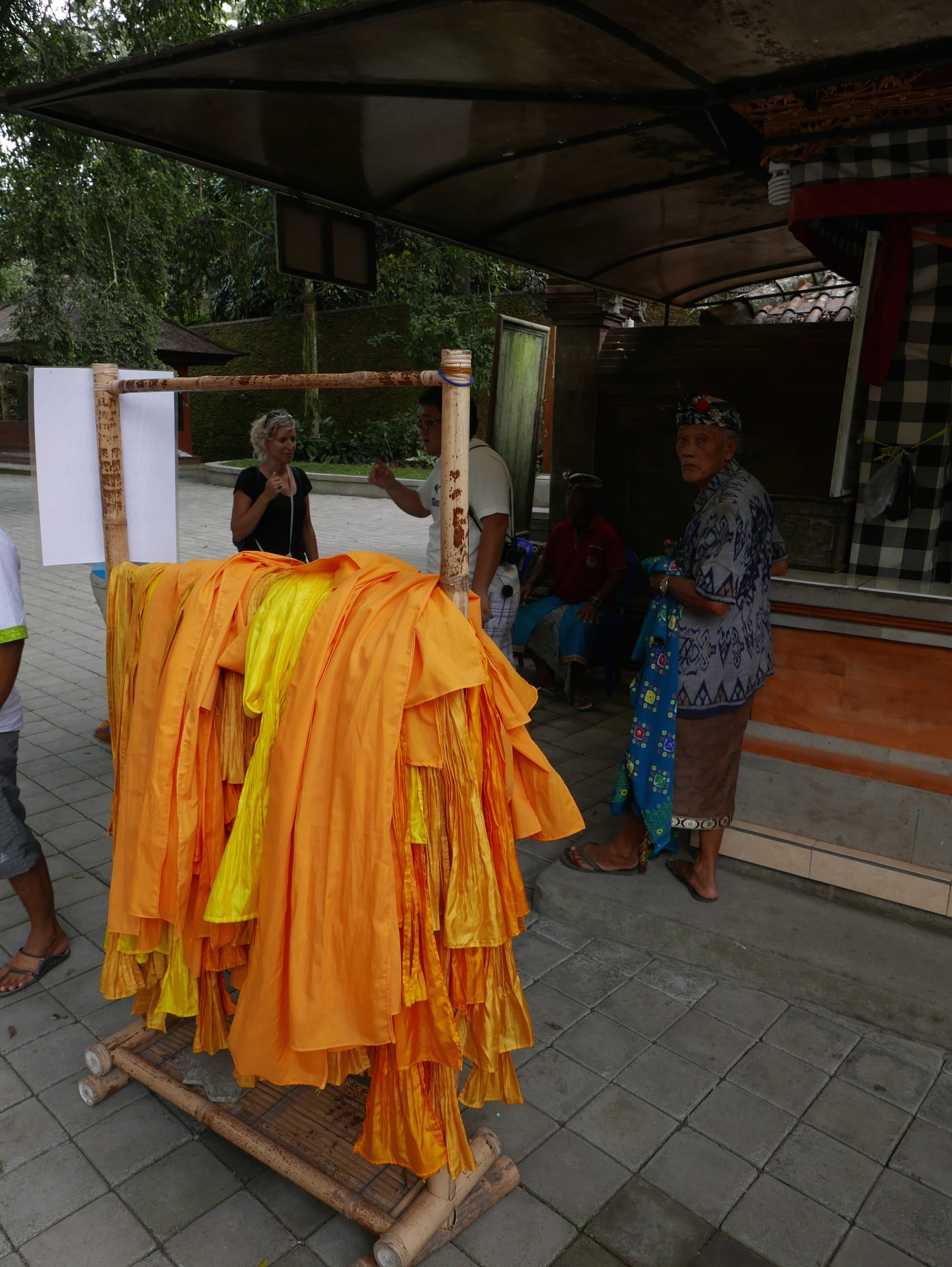 Photo by Author — orange sashes for visitors to the Pura Tirta Empul (Tirta Empul Temple), Bali, Indonesia