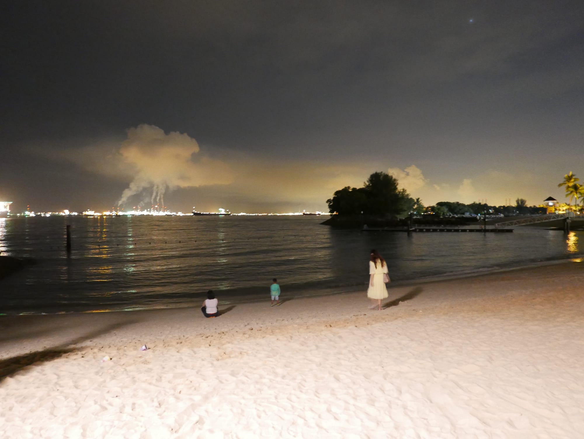 Photo by Author — industrial complexes viewed from Siloso Beach, Singapore, at night