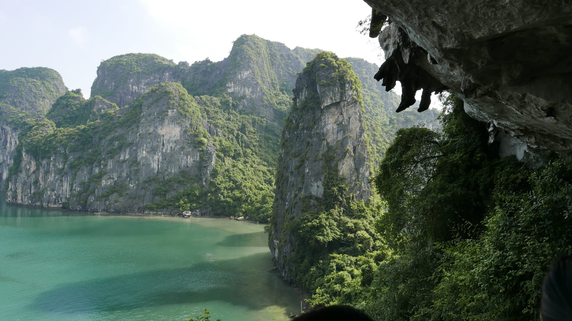 Photo by Author — the mysterious feet hanging over the edge of a cliff — Surprise Cave, Ha Long Bay, Vietnam