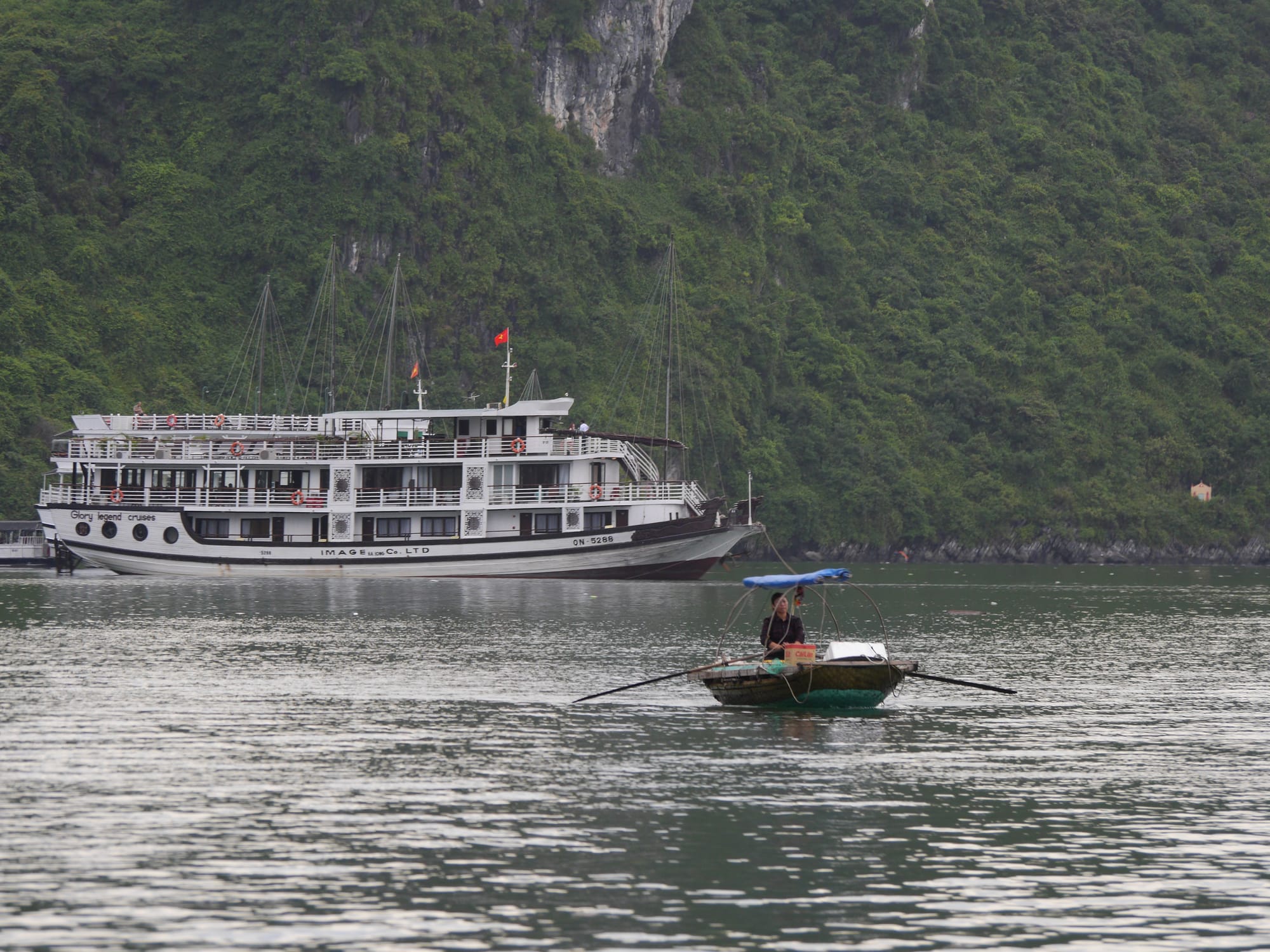 Photo by Author — a local ‘seller’ moving between tourist boats — Ha Long Bay, Vietnam