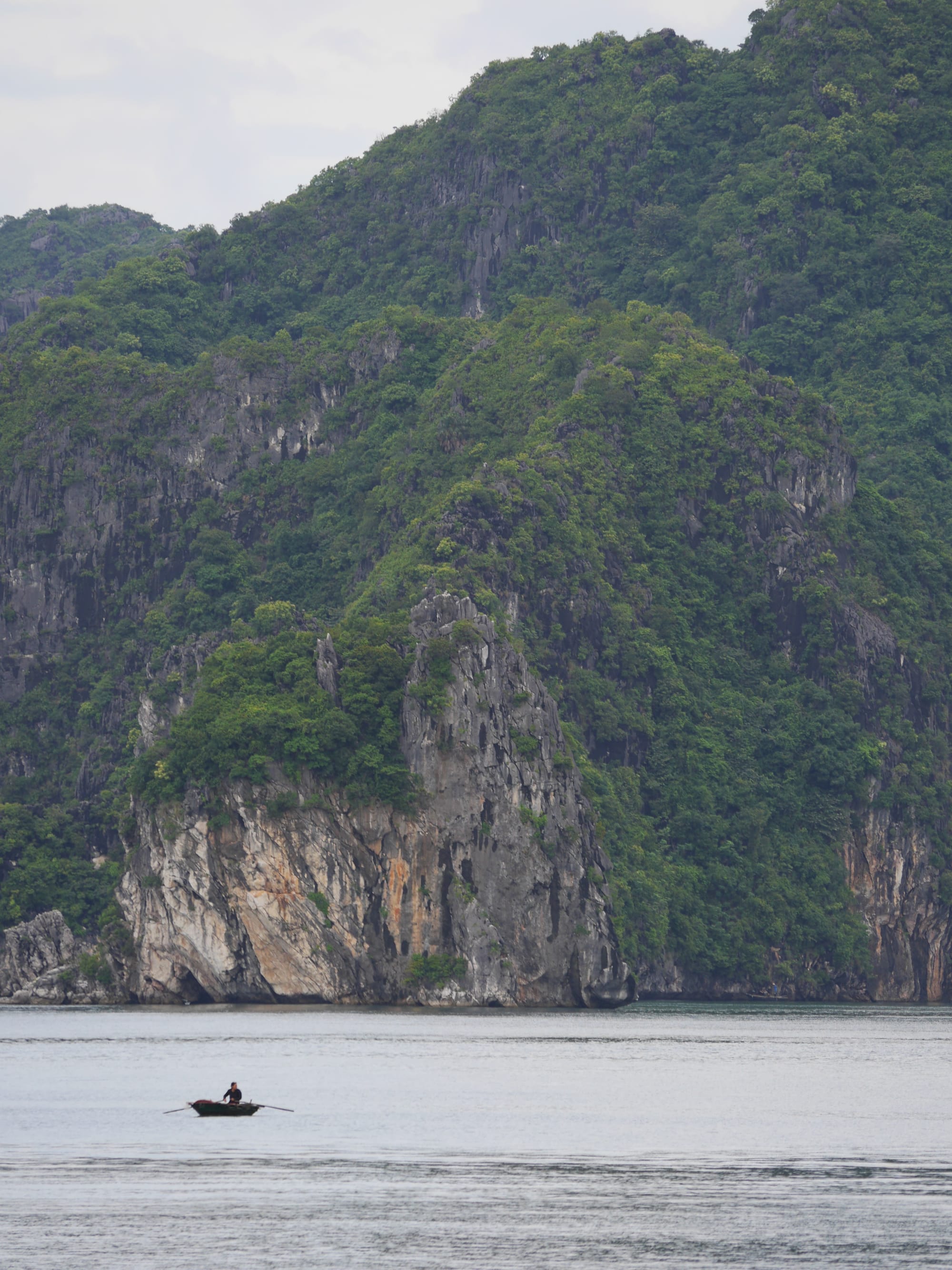 Photo by Author — a local in a boat — Ha Long Bay, Vietnam