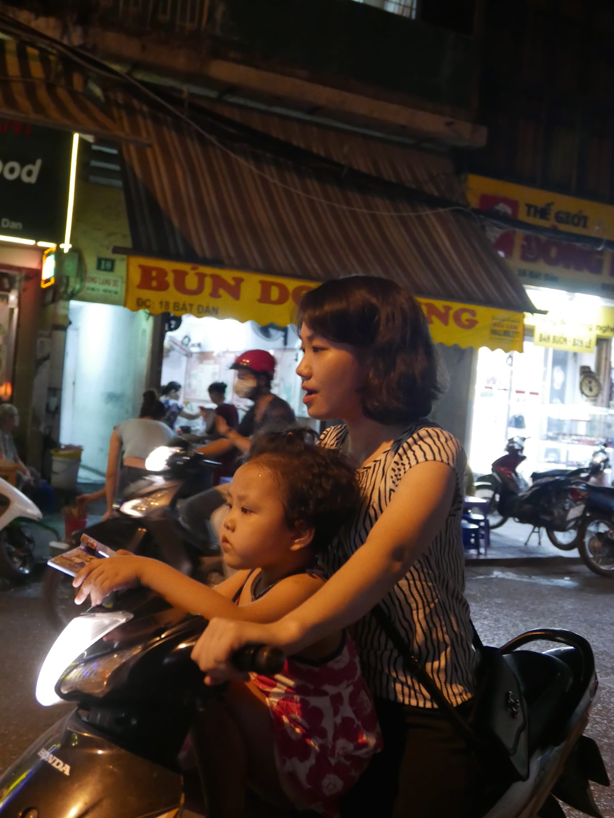 Photo by Author — mother and child on a motorbike in Hanoi, Vietnam