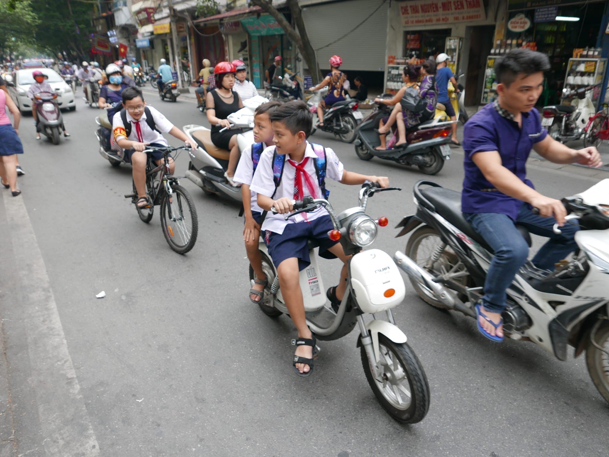 Photo by Author — school kids on an electric motorbike in Hanoi, Vietnam