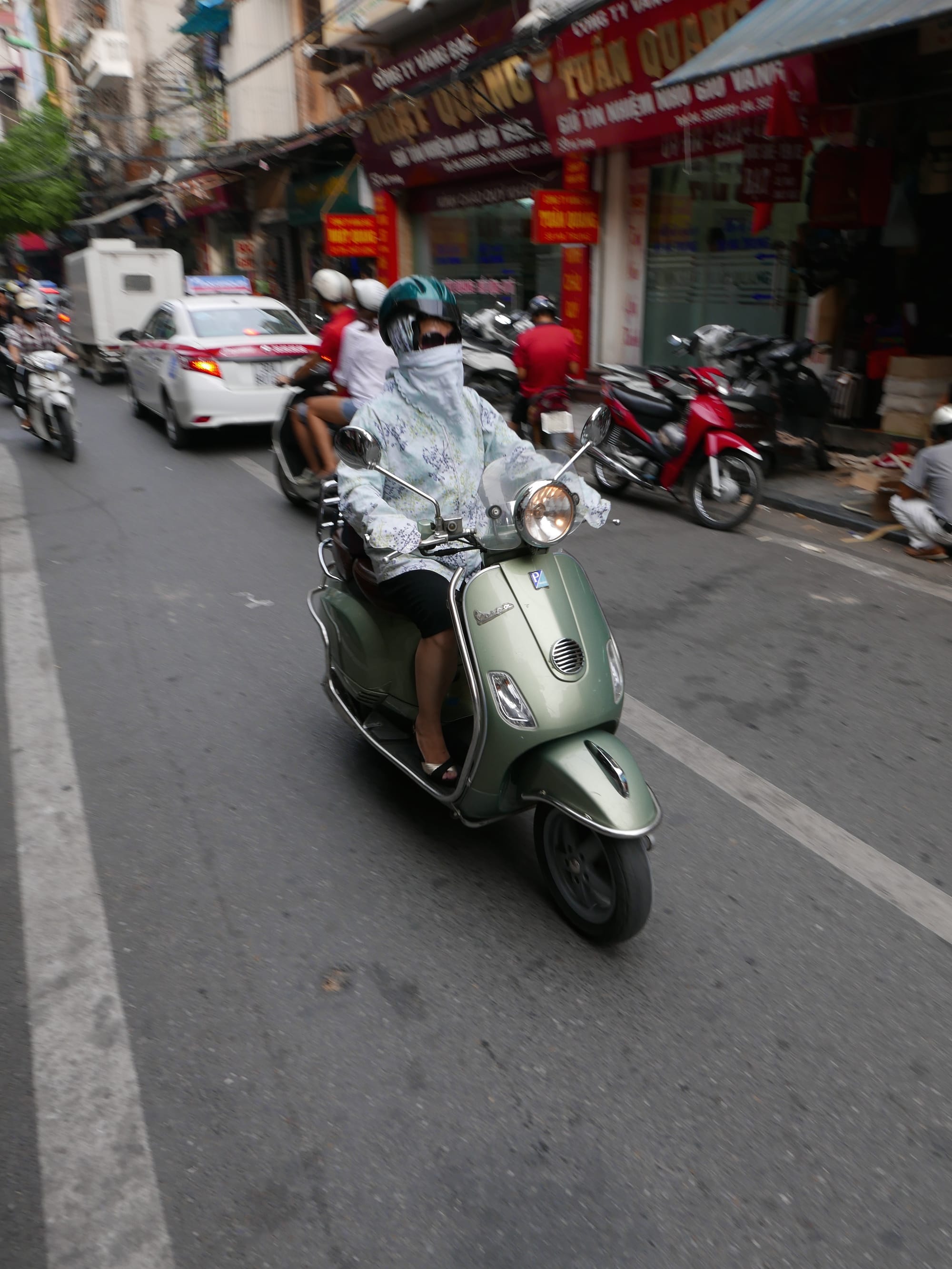 Photo by Author — sun protection on a motorbike in Hanoi, Vietnam