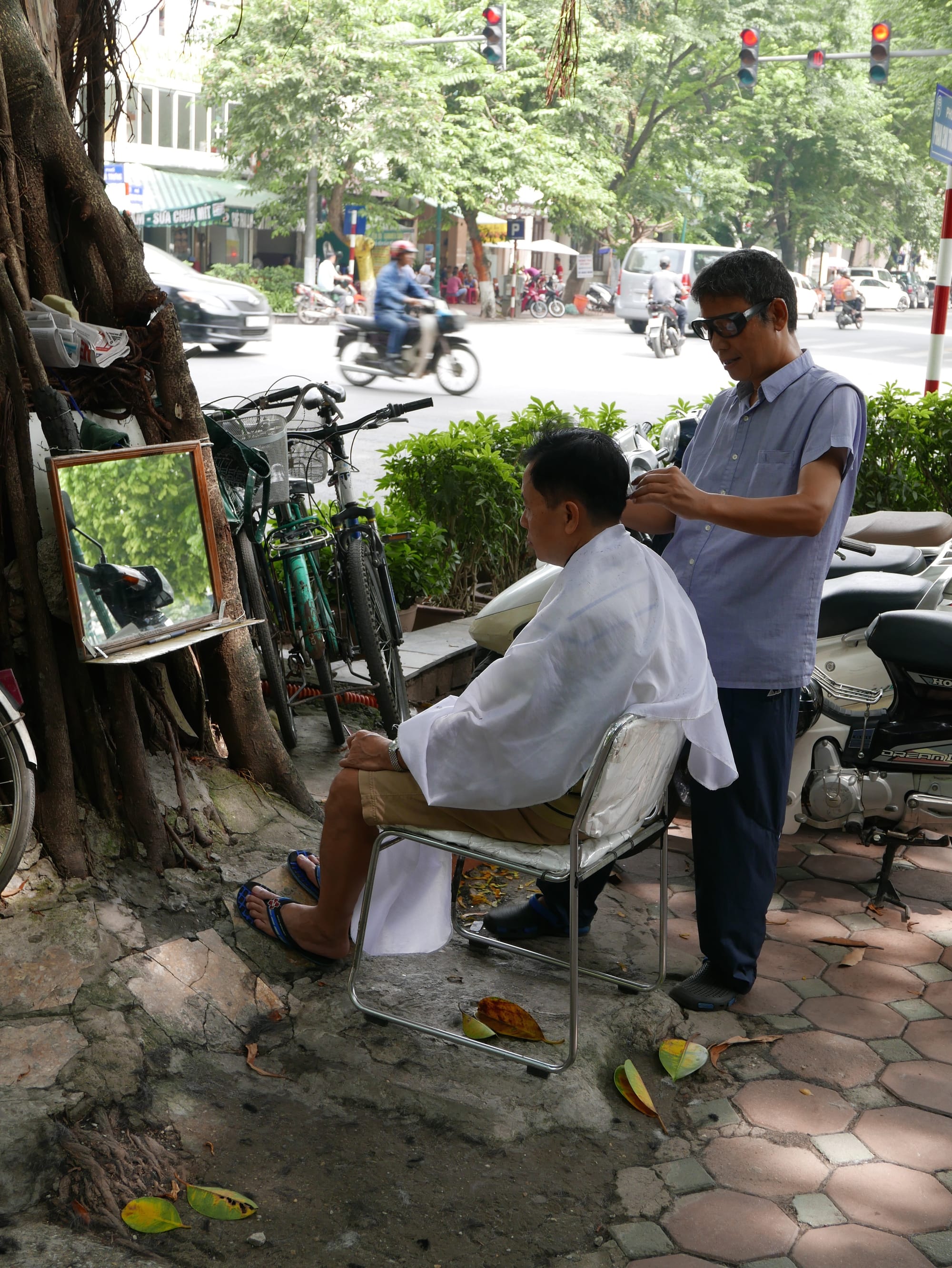 Photo by Author — street barber — Hanoi, Vietnam