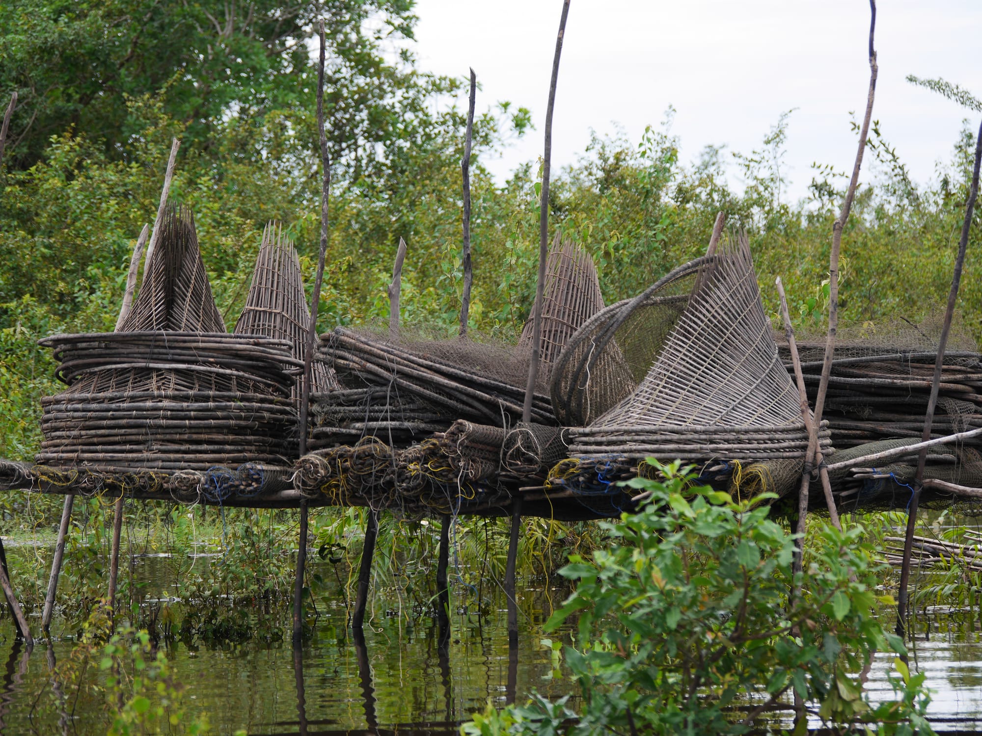 Photo by Author — a collection of fishing traps — Mechrey Floating Village, Siem Reap, Cambodia