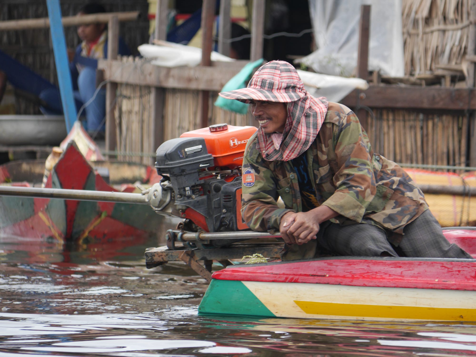 Photo by Author — a villager and his big boat engine — Mechrey Floating Village, Siem Reap, Cambodia