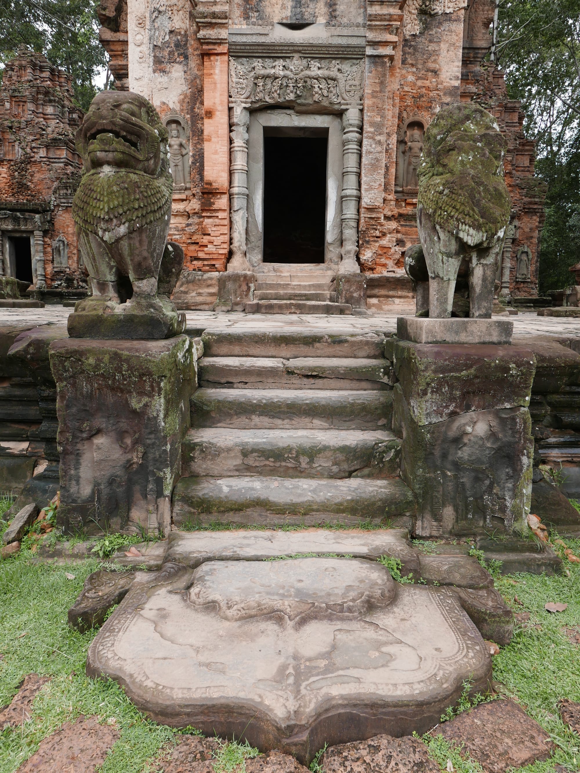 Photo by Author — a pair of chinthes (lions) guarding the steps up to a shrine — Preah Ko (ប្រាសាទព្រះគោ), Angkor Archaeological Park, Angkor, Cambodia