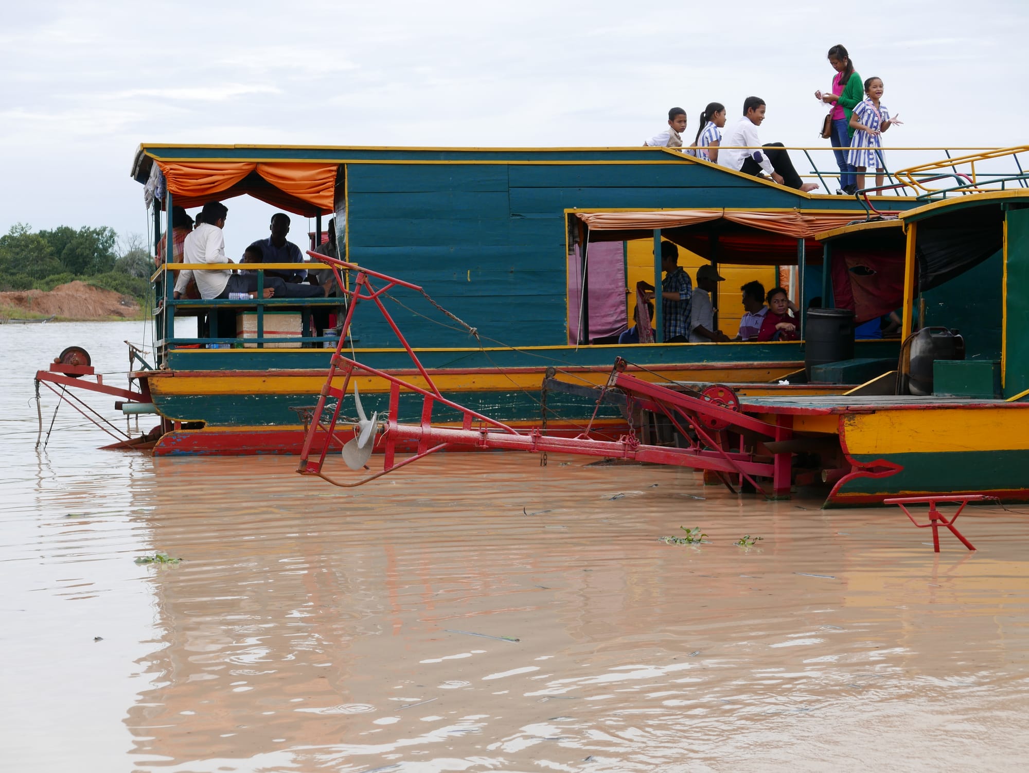 Photo by Author — interesting engine, steering, and propeller set up on the boats — Mechrey Floating Village, Siem Reap, Cambodia