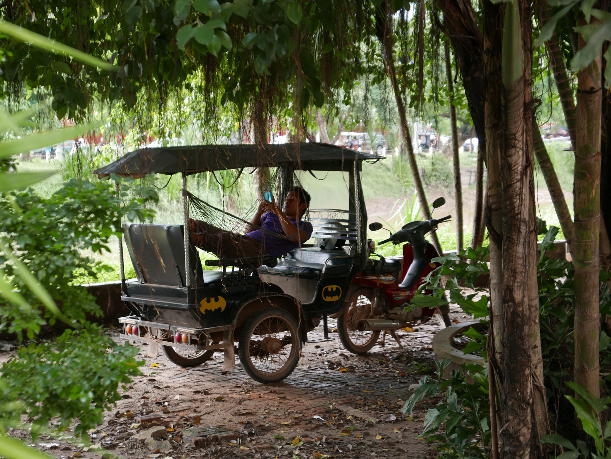 Photo by Author — a Tuk Tuk driver having a nap — Tuk Tuks of Siem Reap, Cambodia