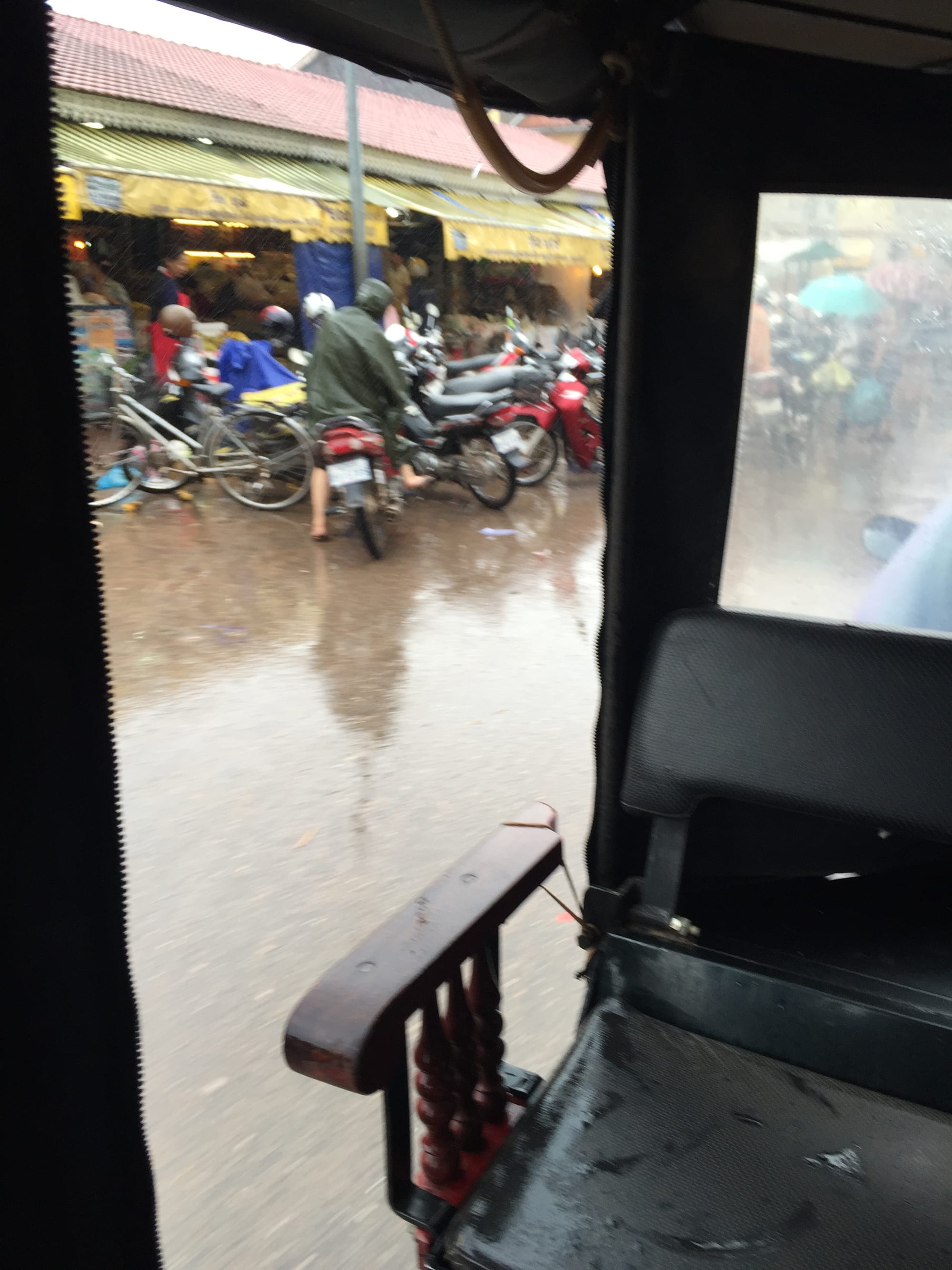 Photo by Author — the view from a Tuk Tuk on a rainy day — Tuk Tuks of Siem Reap, Cambodia