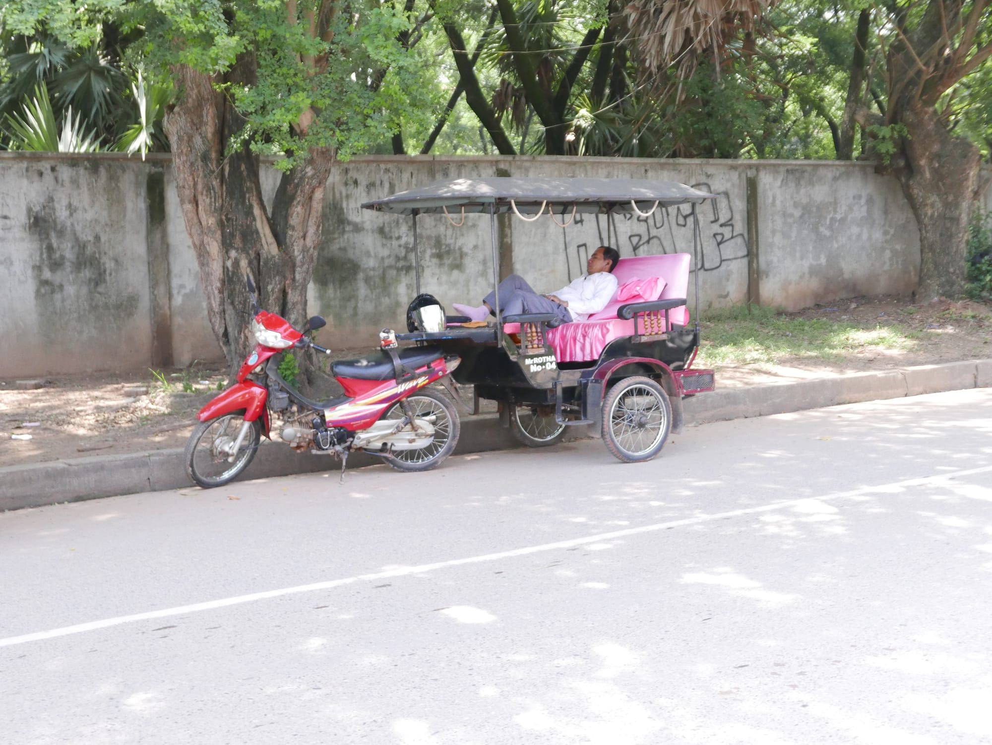 Photo by Author — a Tuk Tuk driver having a nap — Tuk Tuks of Siem Reap, Cambodia