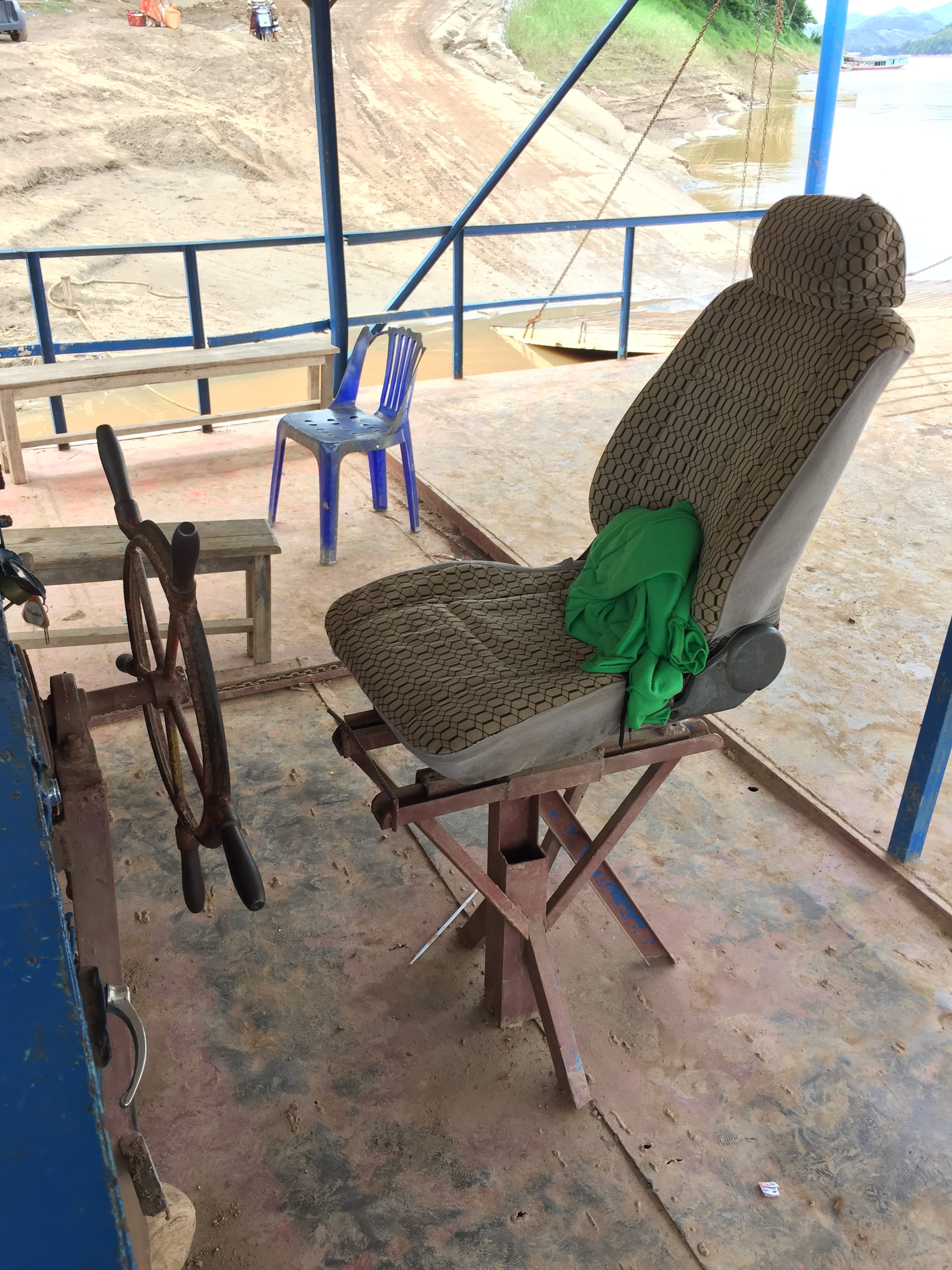 Photo by Author — the captain's seat on the ferry across the Mekong from Luang Prabang (ຫລວງພະບາງ/ຫຼວງພະບາງ) to Ban Xieng Man