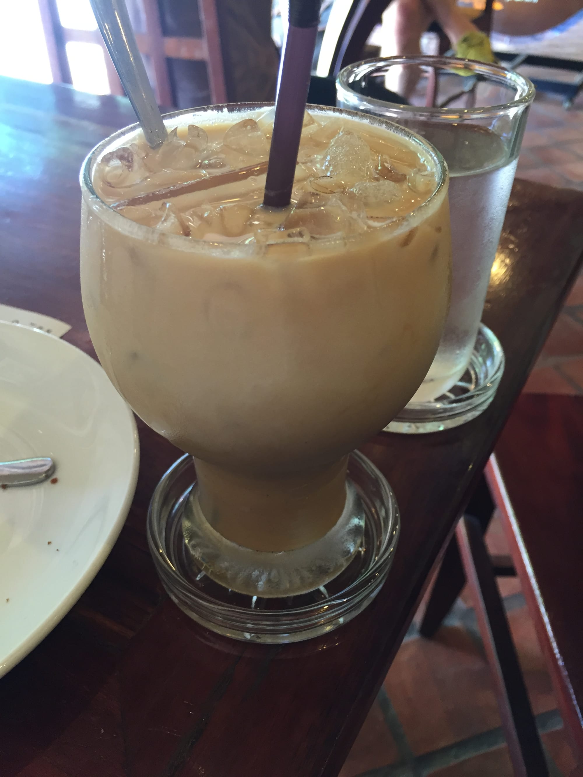 Photo by Author — an iced latte at the Saffron Café, Luang Prabang (ຫລວງພະບາງ/ຫຼວງພະບາງ), Laos