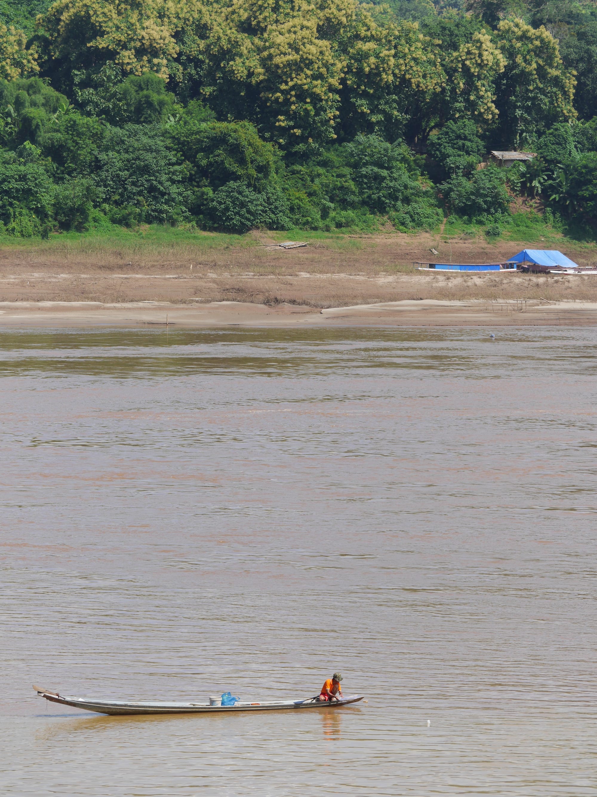 Photo by Author — a small boat on the Mekong River — Luang Prabang (ຫລວງພະບາງ/ຫຼວງພະບາງ), Laos