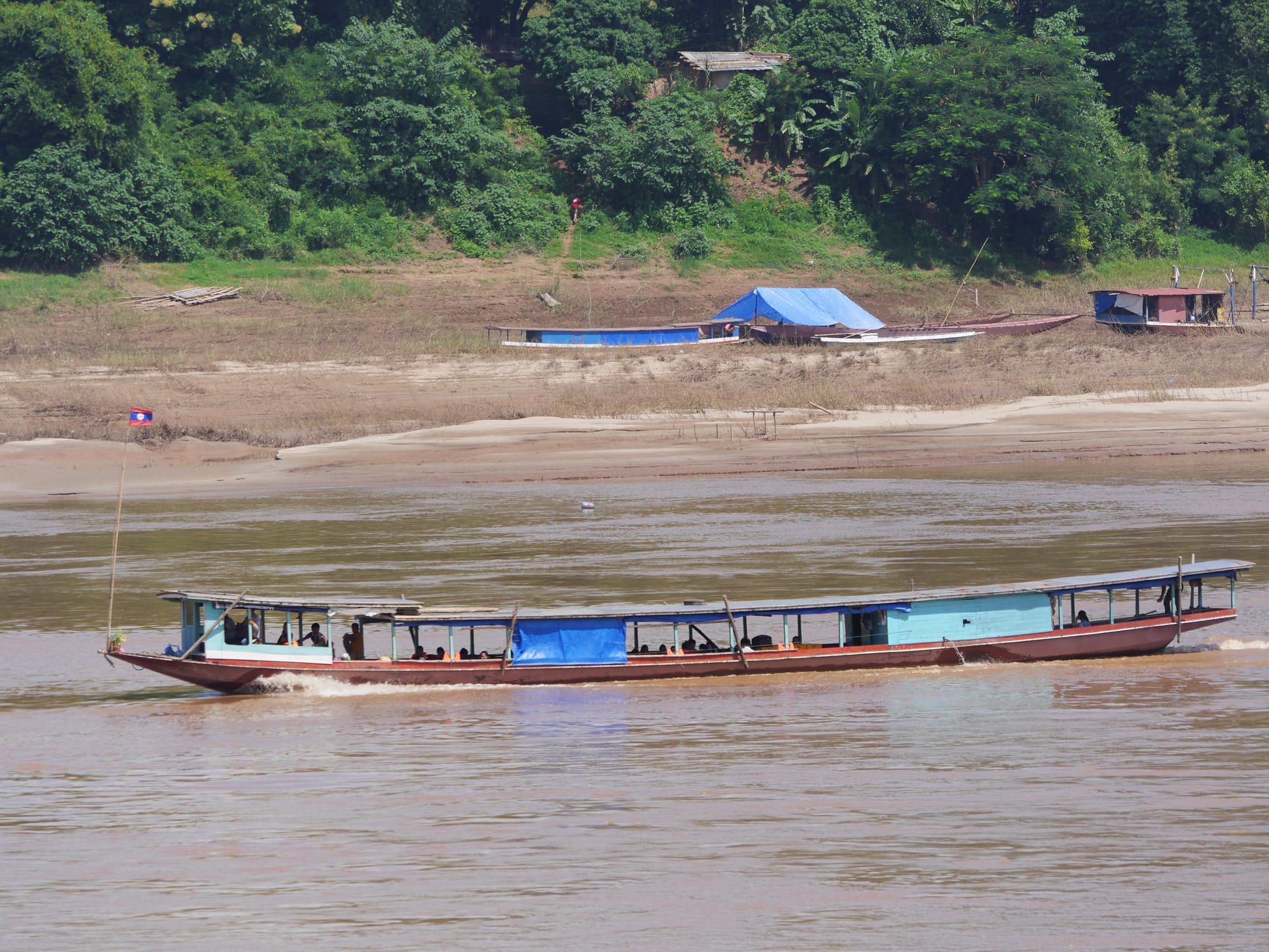 Photo by Author — a boat on the Mekong River — Luang Prabang (ຫລວງພະບາງ/ຫຼວງພະບາງ), Laos