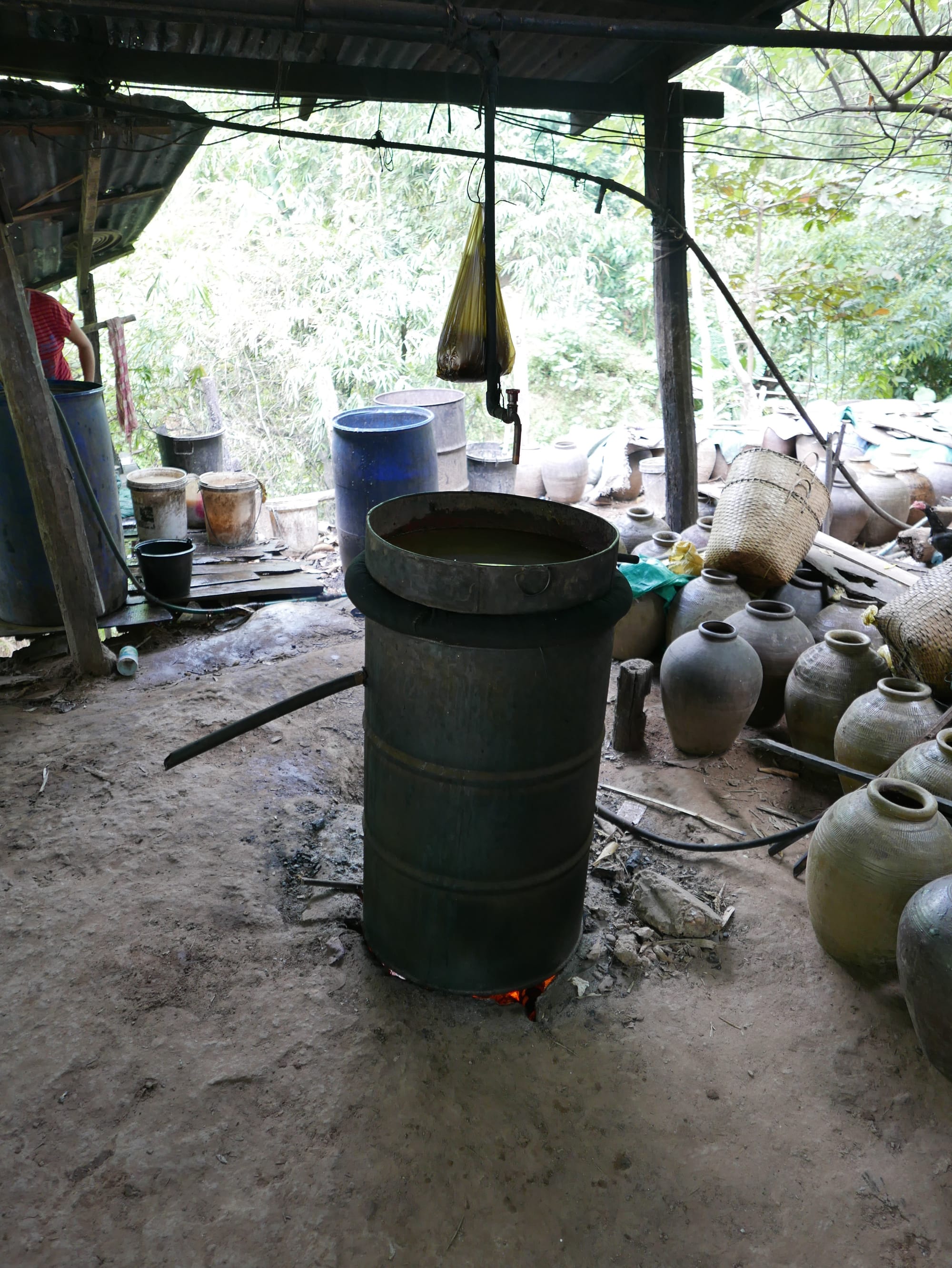 Photo by Author — distillation vessel for Lao Whisky — Ban Xanghai (ບ້ານຊຽງຮາຍ): Liquor & Silk Village, Luang Prabang (ຫລວງພະບາງ/ຫຼວງພະບາງ), Laos — not the fermentation pots in the right