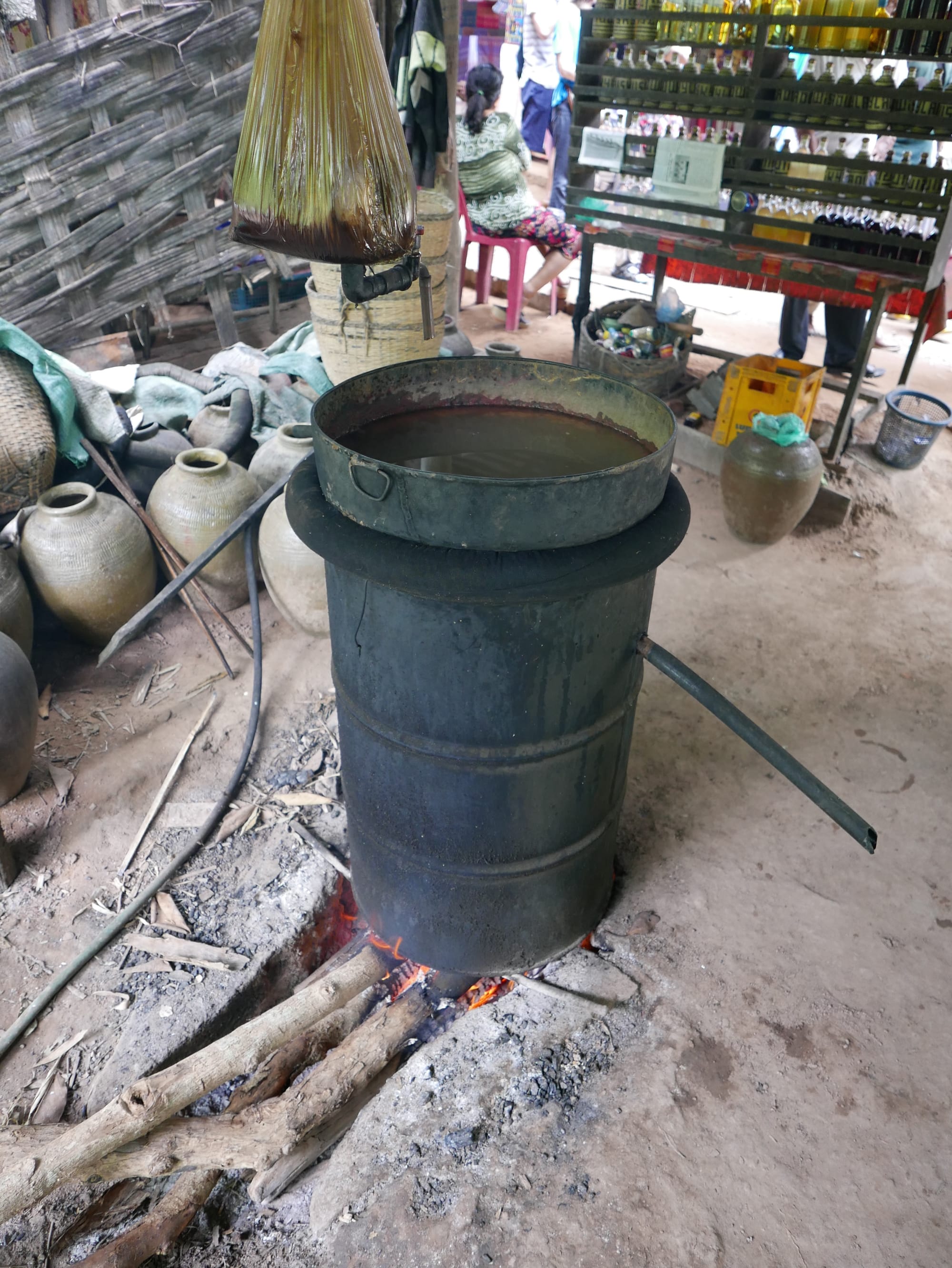 Photo by Author — distillation in progress — Ban Xanghai (ບ້ານຊຽງຮາຍ): Liquor & Silk Village, Luang Prabang (ຫລວງພະບາງ/ຫຼວງພະບາງ), Laos