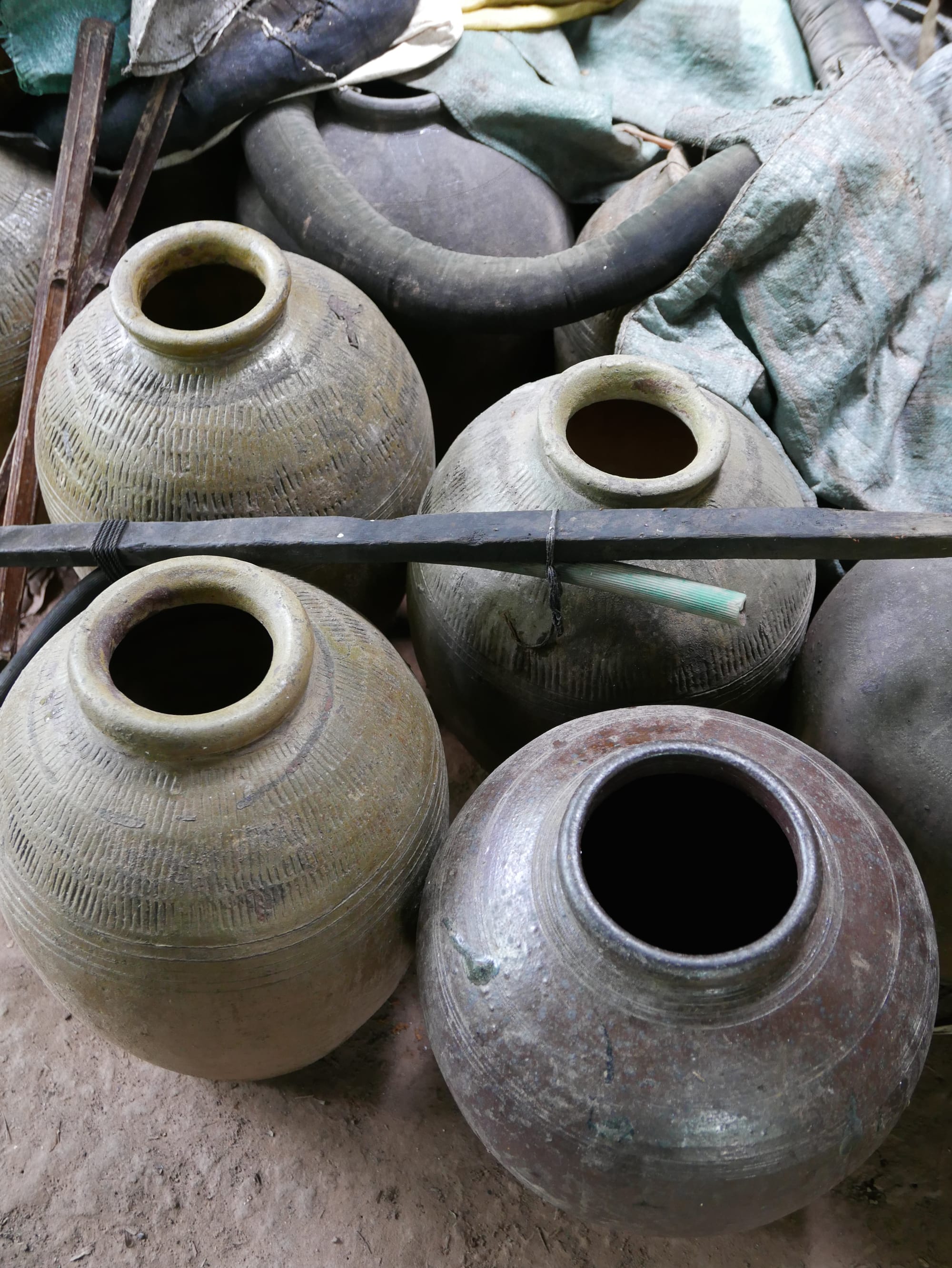 Photo by Author — rice fermentation jars — Ban Xanghai (ບ້ານຊຽງຮາຍ): Liquor & Silk Village, Luang Prabang (ຫລວງພະບາງ/ຫຼວງພະບາງ), Laos