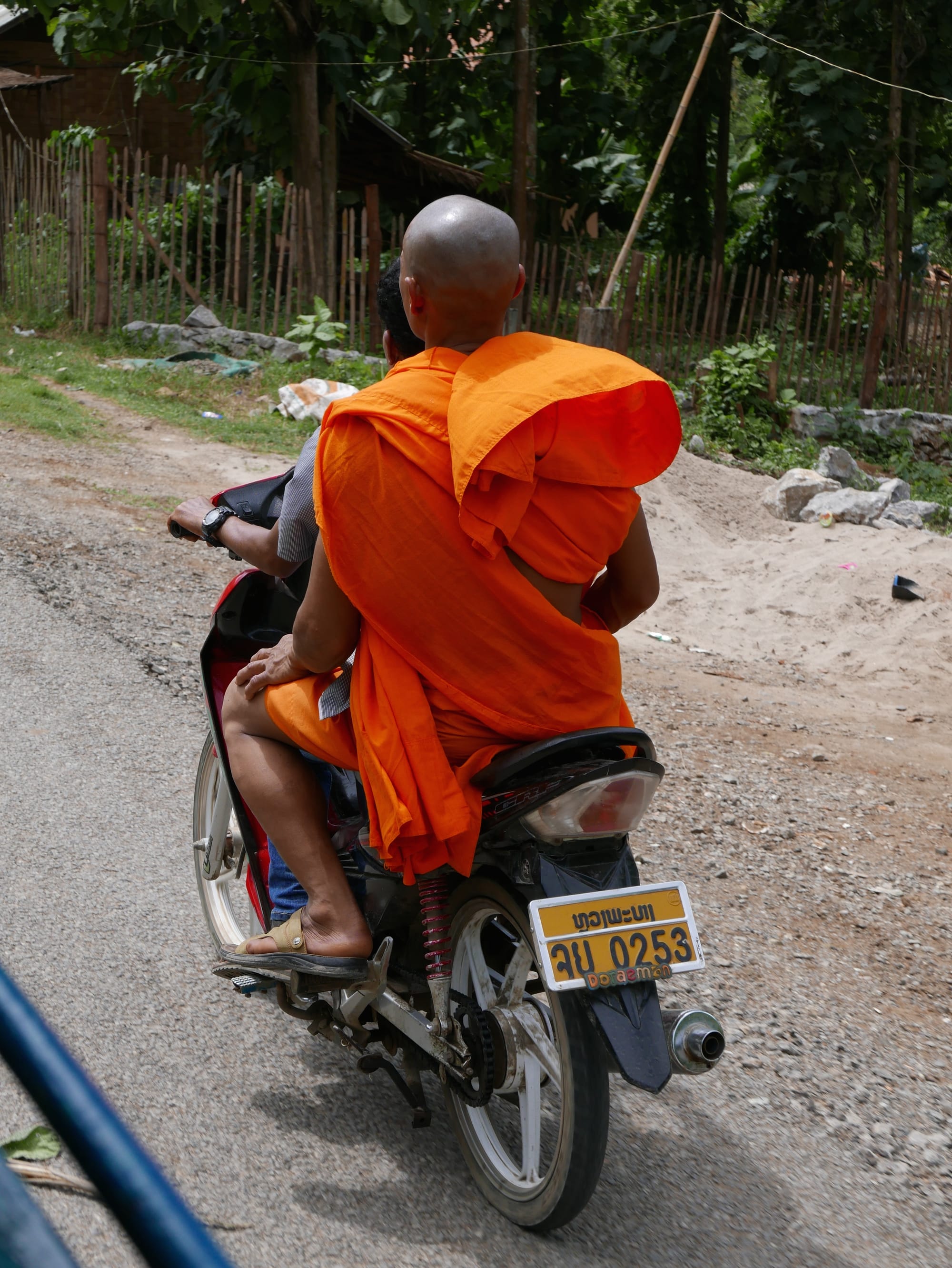 Photo by Author — motorbikes in Luang Prabang (ຫລວງພະບາງ/ຫຼວງພະບາງ), Laos — a monk on a bike