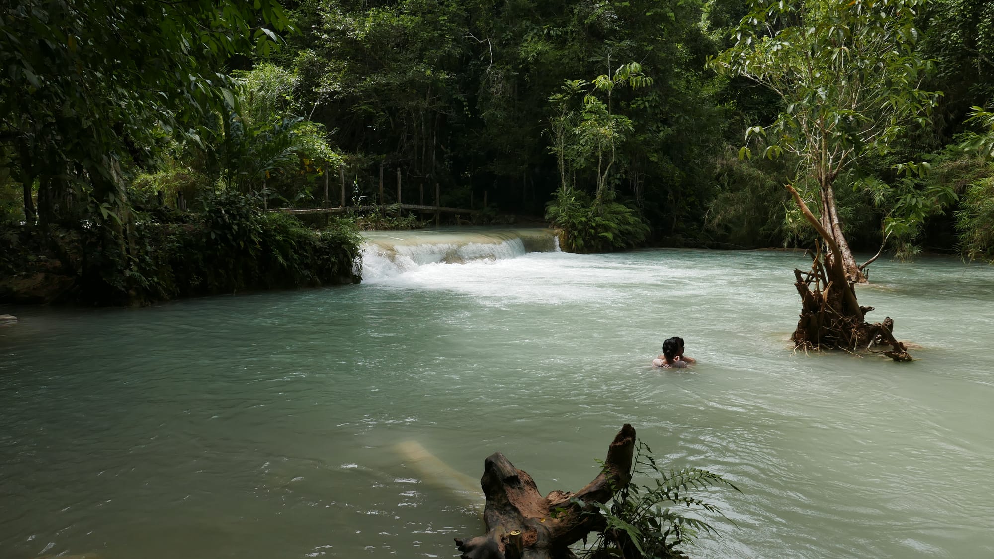 Photo by Author — the first fall and pool — Kuang Si Waterfall (ນ້ຳຕົກຕາດ ກວາງຊີ), Laos — the lower pools