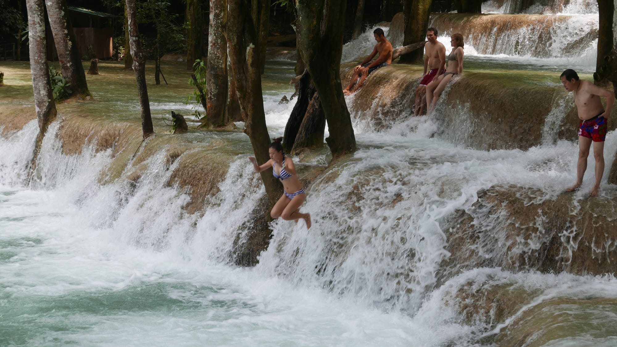 Photo by Author — a photo burst of jumping the falls — Tad Sae Waterfalls (ຕາດແສ້), Luang Prabang (ຫລວງພະບາງ/ຫຼວງພະບາງ), Laos