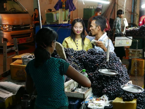 An evening stroll in downtown Yangon, Myanmar (Burma) - a grape seller